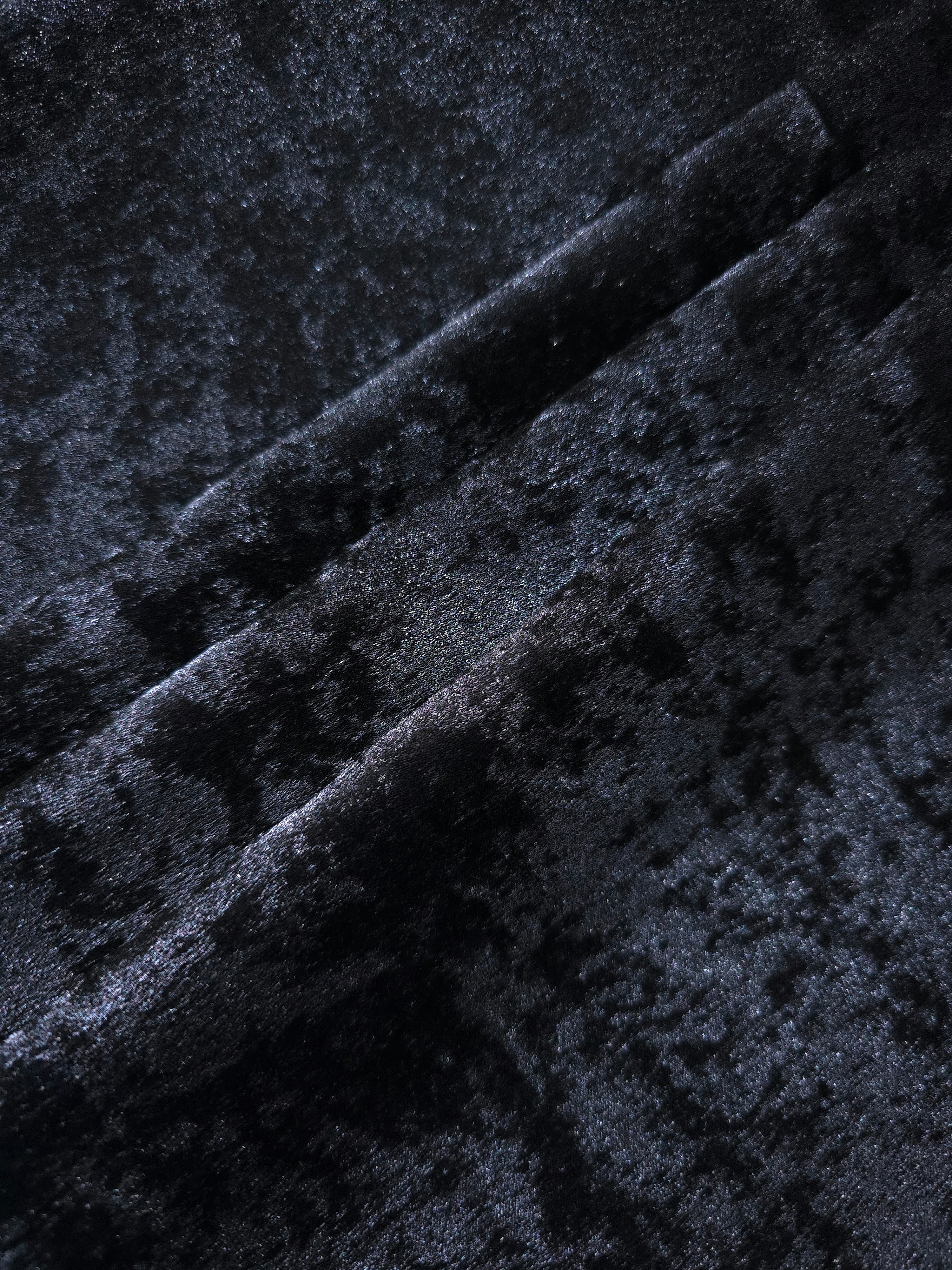 Midnight Navy Lurex Italiano fabric in diagonal folds showing metallic sheen and drape for eveningwear.