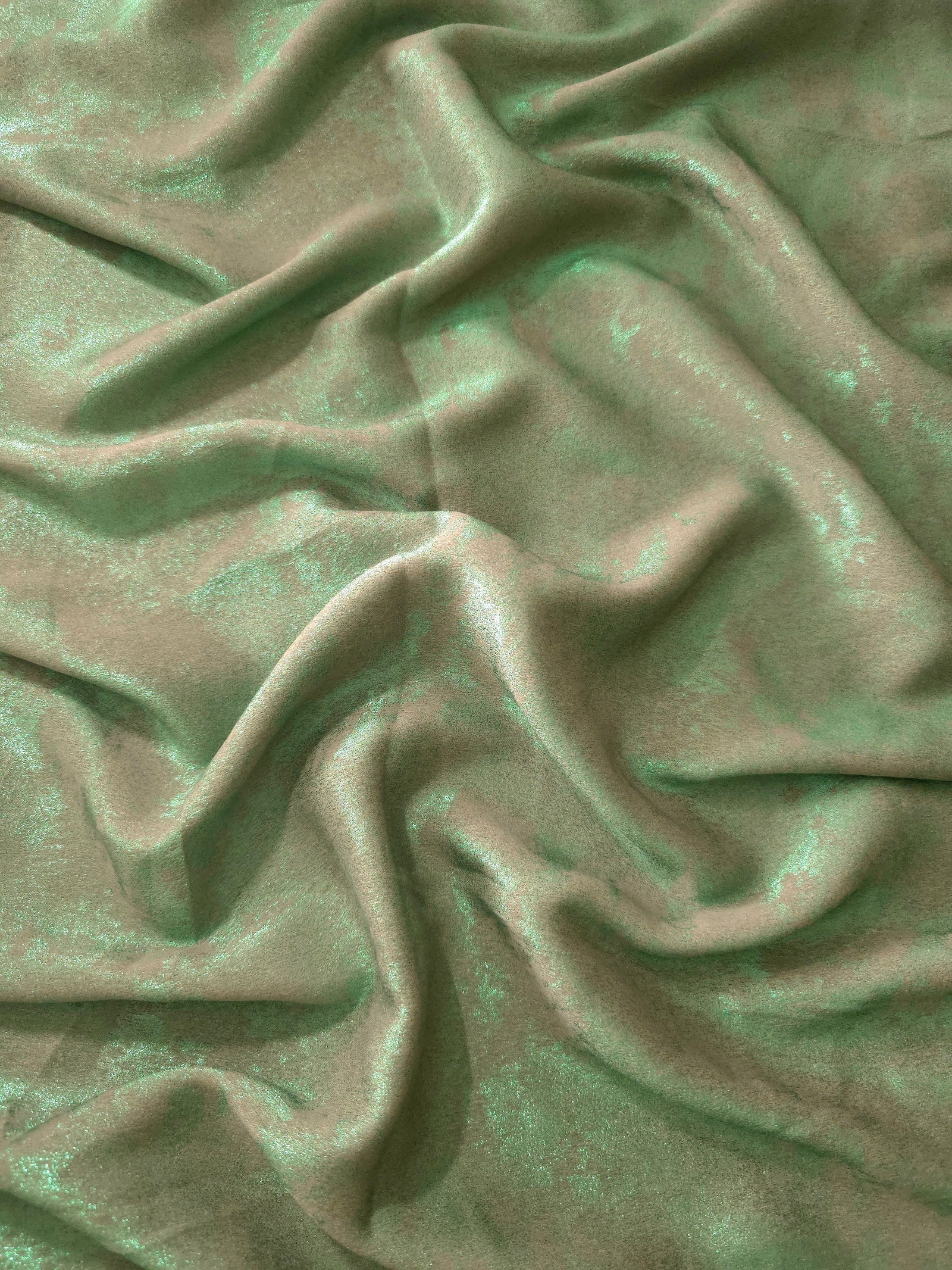 Flowing folds of Mint Sage Lurex Italiano fabric highlighting drape for abayas, kaftans and dresses.