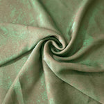 Rosette drape of Mint Sage Lurex Italiano fabric emphasizing shimmer for kaftans and occasionwear.