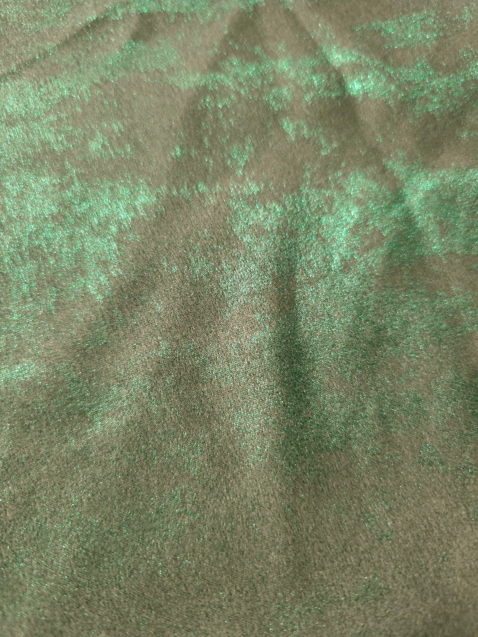 Macro close-up of Mint Sage Lurex Italiano fabric revealing metallic texture for designer apparel.