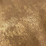 Nude Gold Lurex Italiano fabric in diagonal folds showing metallic sheen and drape for eveningwear.