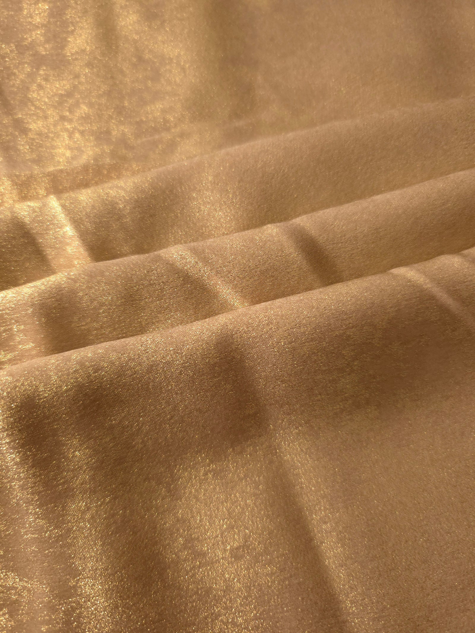 Flowing folds of Nude Gold Lurex Italiano fabric highlighting drape for abayas, kaftans and dresses.