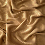 Macro close-up of Nude Gold Lurex Italiano fabric revealing metallic texture for designer apparel.