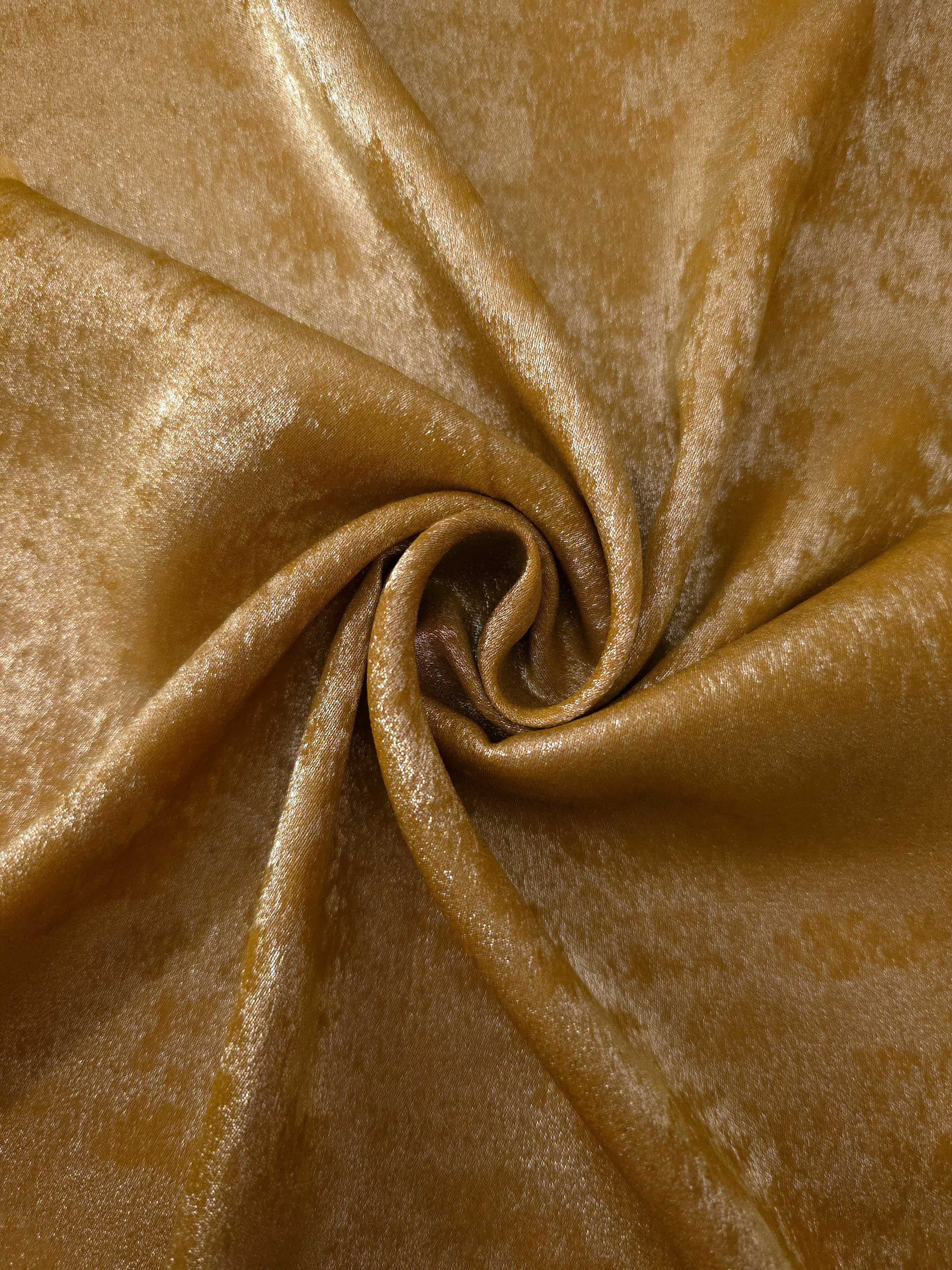 Ochre Gold Lurex Italiano metallic fabric in a rosette drape with golden shimmer