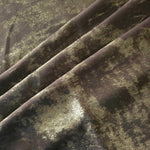 Olive Bronze Lurex Italiano fabric arranged in diagonal folds to show its metallic sheen and drape for eveningwear.