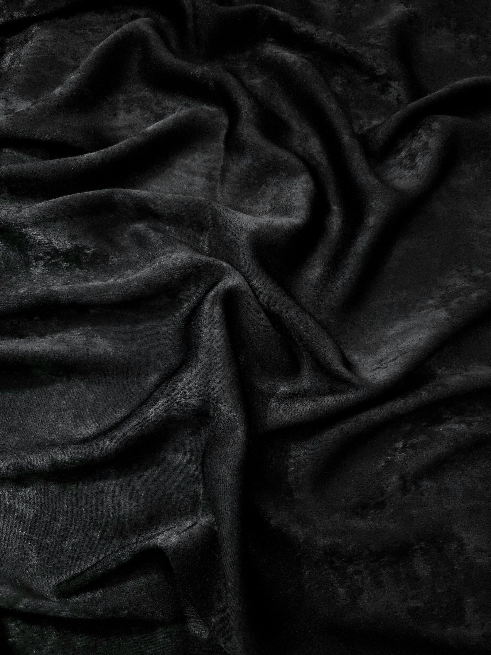 Flat view of Onyx Black Lurex Italiano fabric showing its metallic foil surface for luxury apparel.