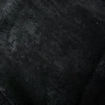 Macro close-up of Onyx Black Lurex Italiano fabric revealing metallic texture for designer apparel.