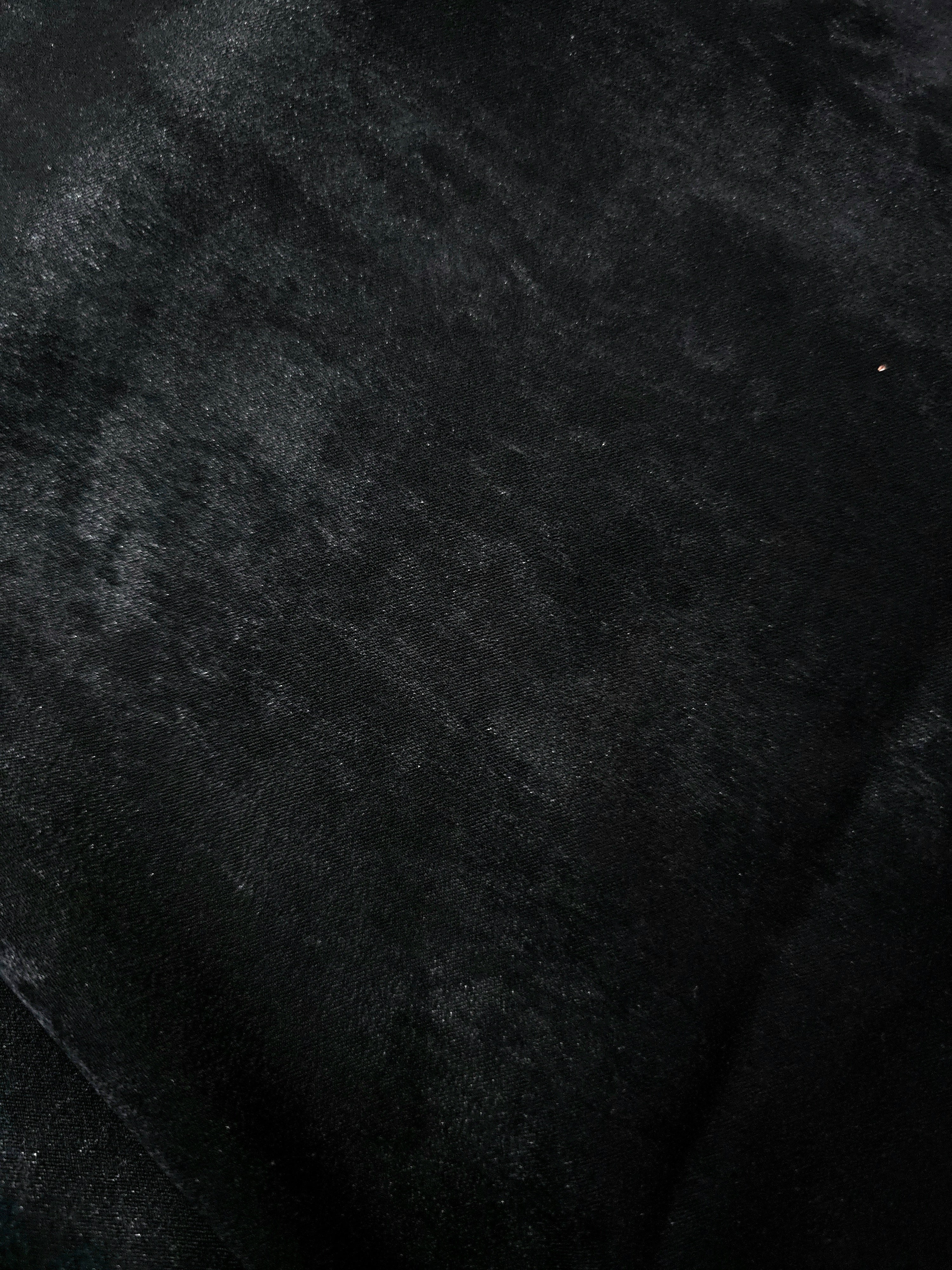 Macro close-up of Onyx Black Lurex Italiano fabric revealing metallic texture for designer apparel.