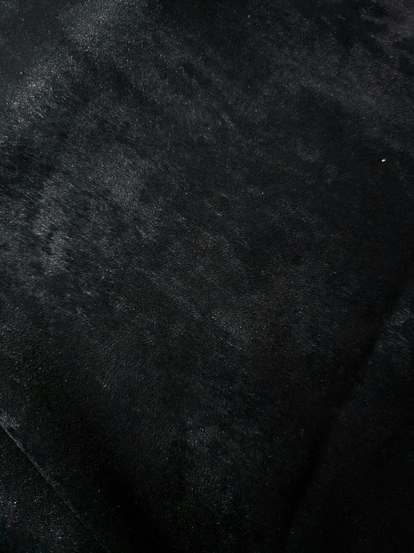 Macro close-up of Onyx Black Lurex Italiano fabric revealing metallic texture for designer apparel.