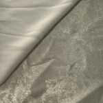 Pearl Silver Lurex Italiano fabric in diagonal folds showing metallic sheen and drape for eveningwear.