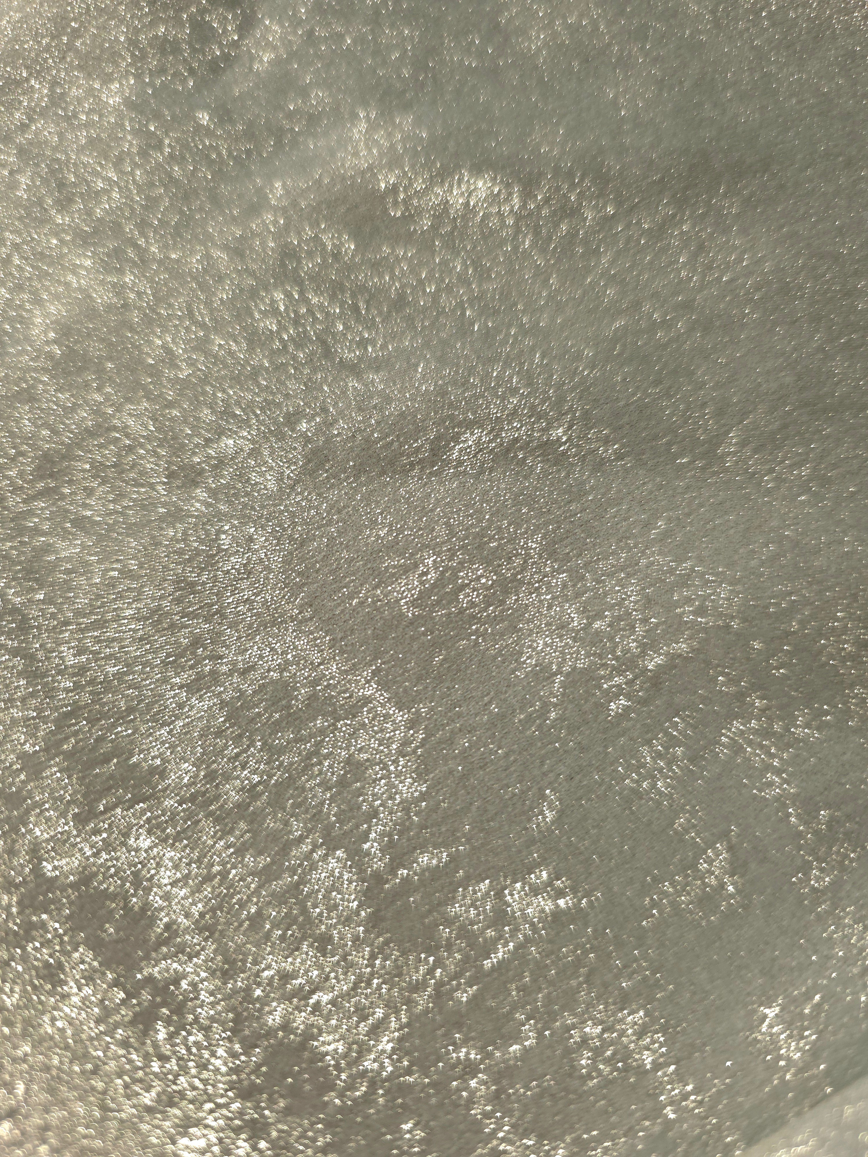 Macro close-up of Pearl Silver Lurex Italiano fabric revealing metallic texture for designer apparel.