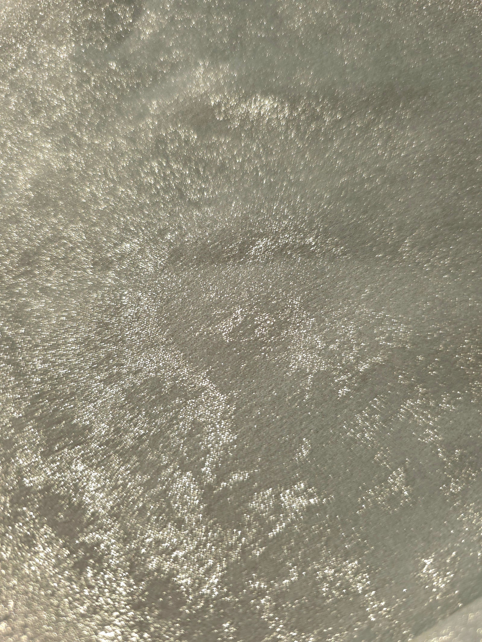 Macro close-up of Pearl Silver Lurex Italiano fabric revealing metallic texture for designer apparel.