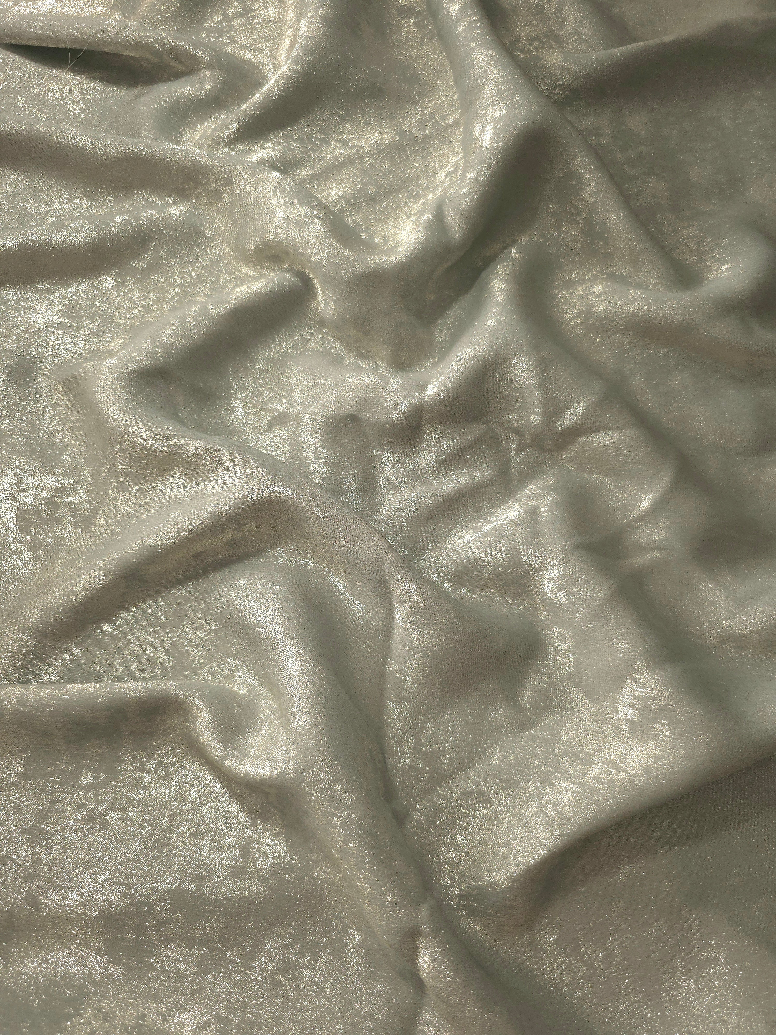 Reverse side of Pearl Silver Lurex Italiano fabric showing the backing and metallic finish for garment production.