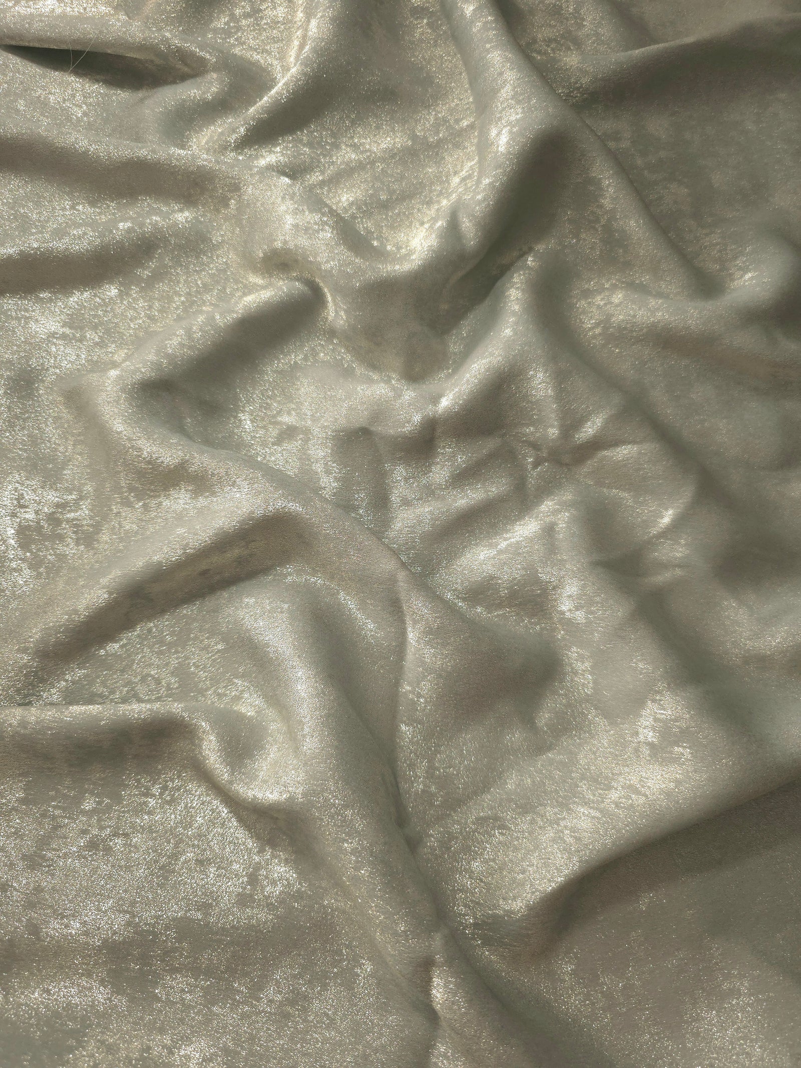 Reverse side of Pearl Silver Lurex Italiano fabric showing the backing and metallic finish for garment production.