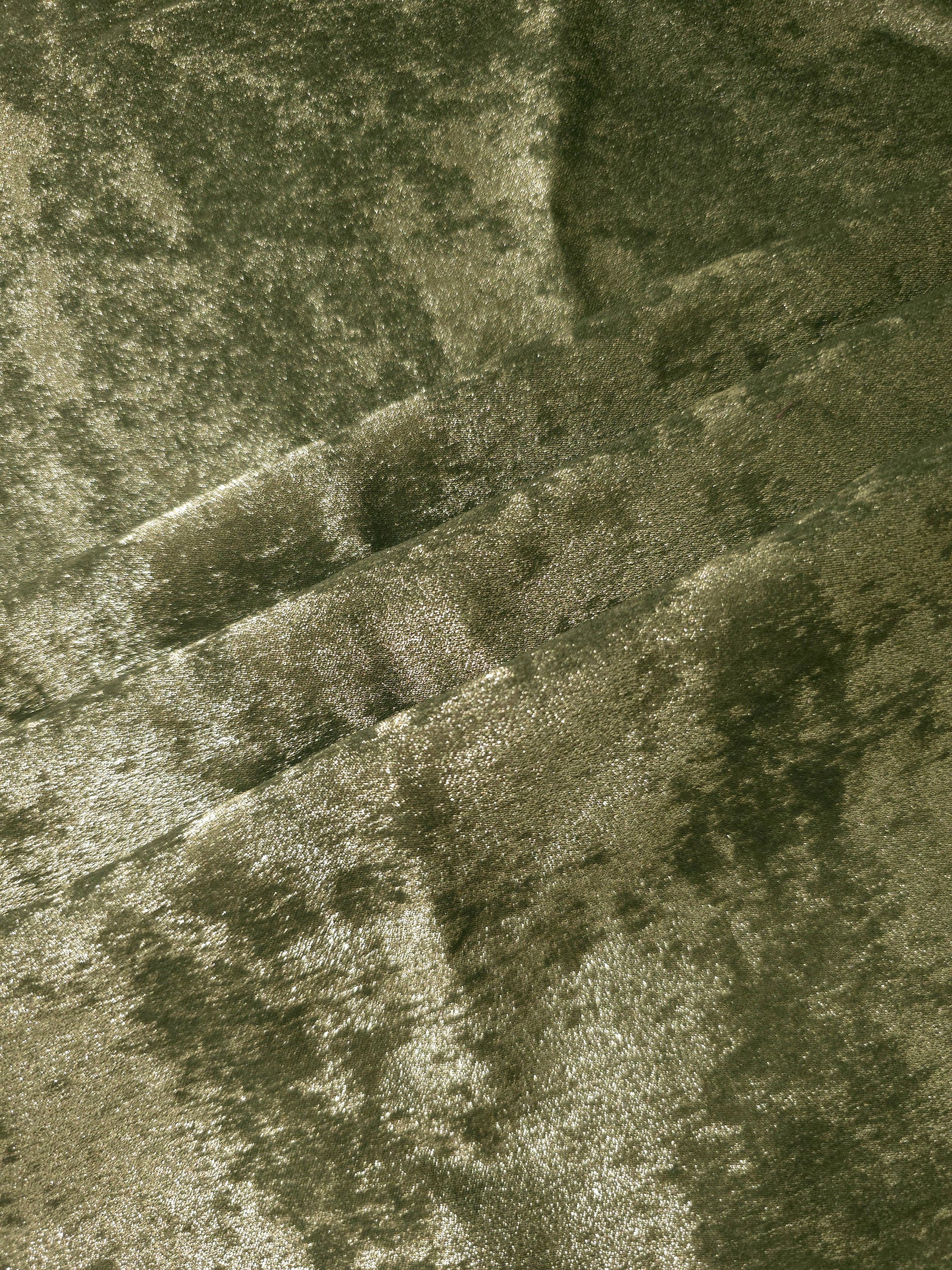 Pewter Olive Lurex Italiano fabric in diagonal folds showing metallic sheen and drape for eveningwear.