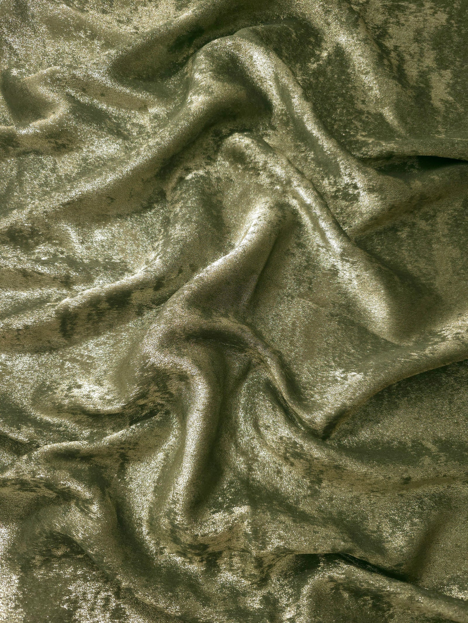 Flowing folds of Pewter Olive Lurex Italiano fabric highlighting drape for abayas, kaftans and dresses.
