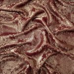 Rose Bronze Lurex Italiano fabric in diagonal folds showing metallic sheen and drape for eveningwear.