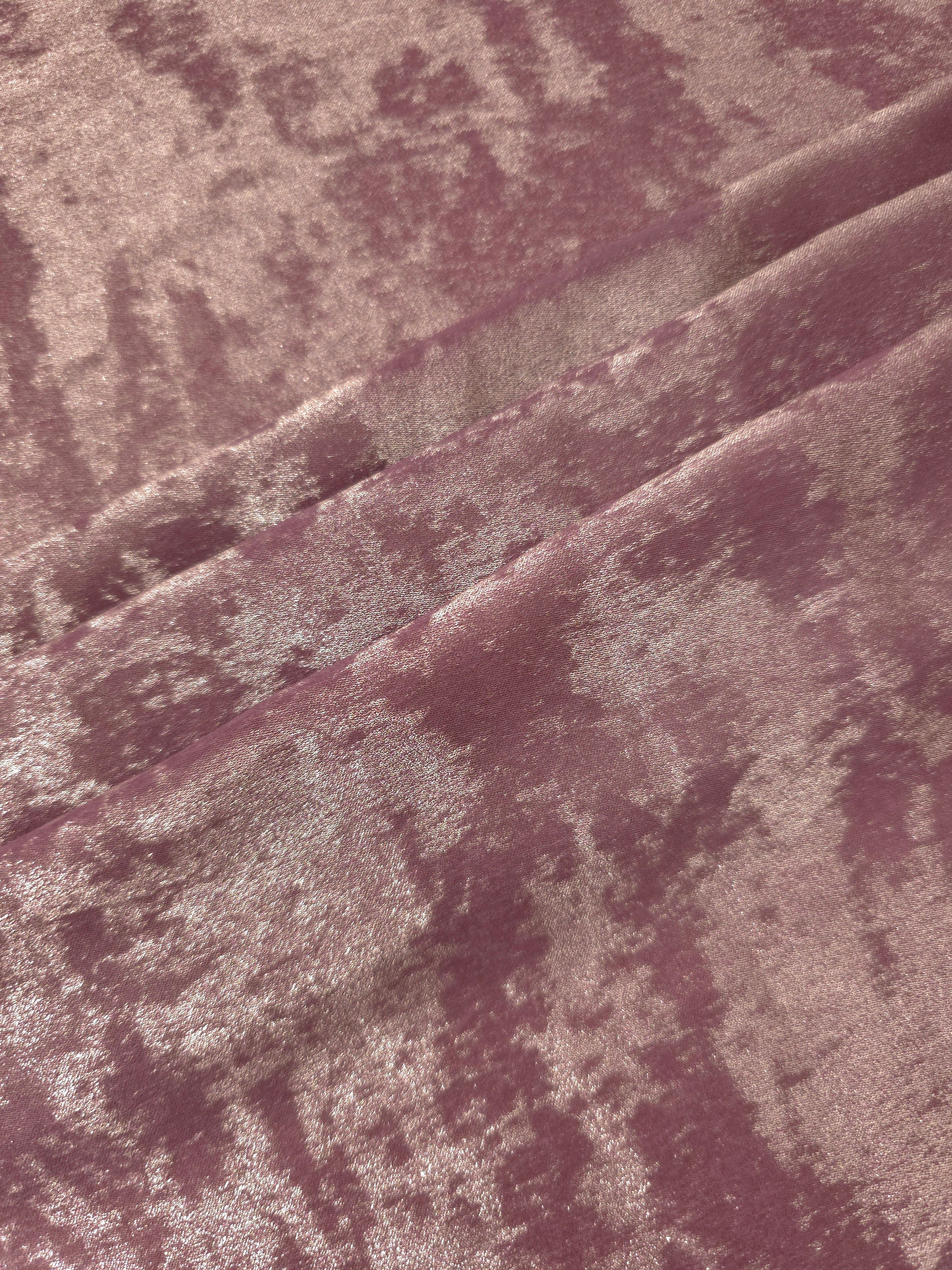 Rose Mauve Lurex Italiano fabric in diagonal folds showing metallic sheen and drape for eveningwear.
