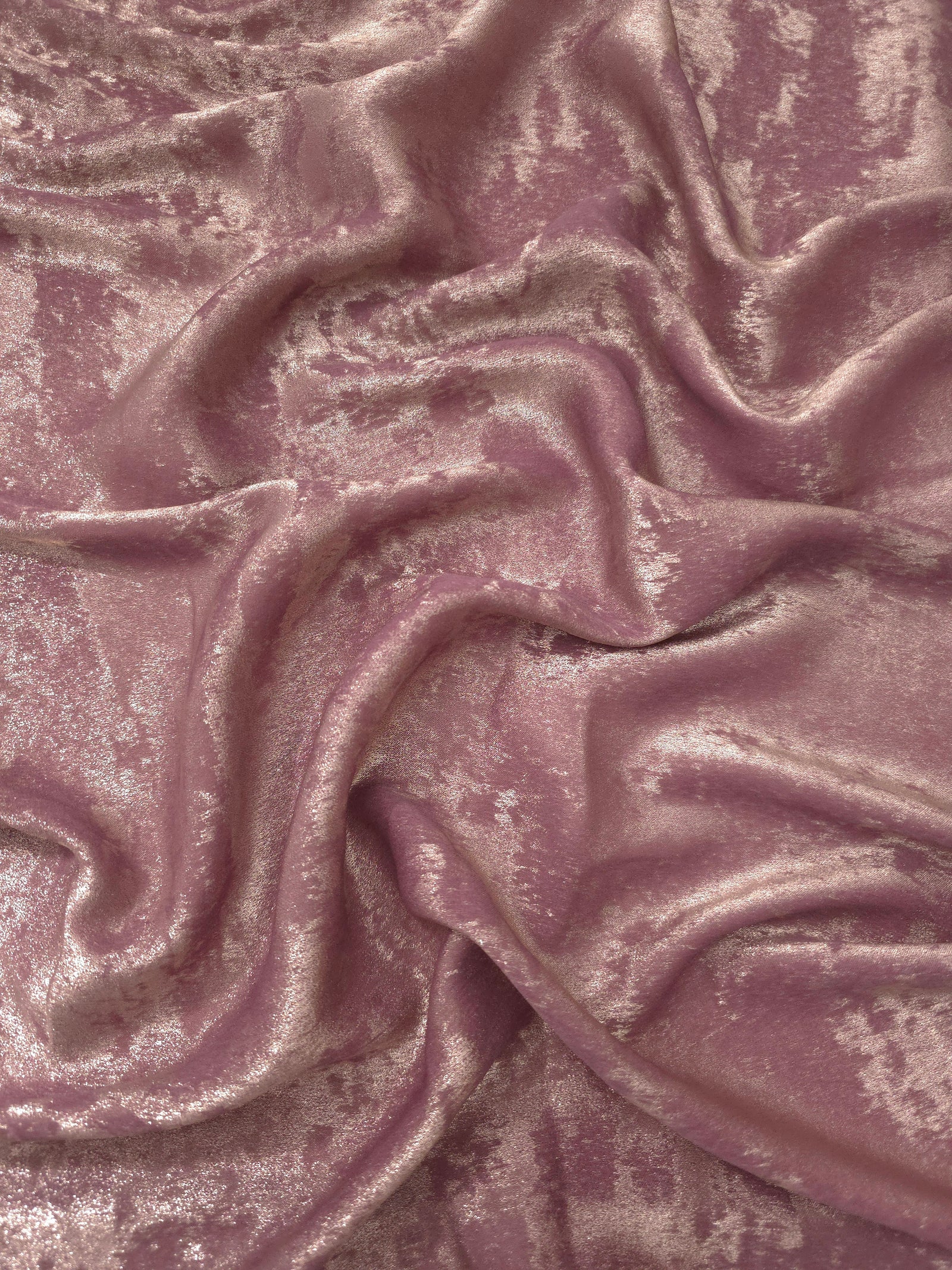 Flowing folds of Rose Mauve Lurex Italiano fabric highlighting drape for abayas, kaftans and dresses.