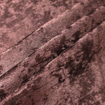 Rosewood Lurex Italiano fabric in diagonal folds showing metallic sheen and drape for eveningwear.
