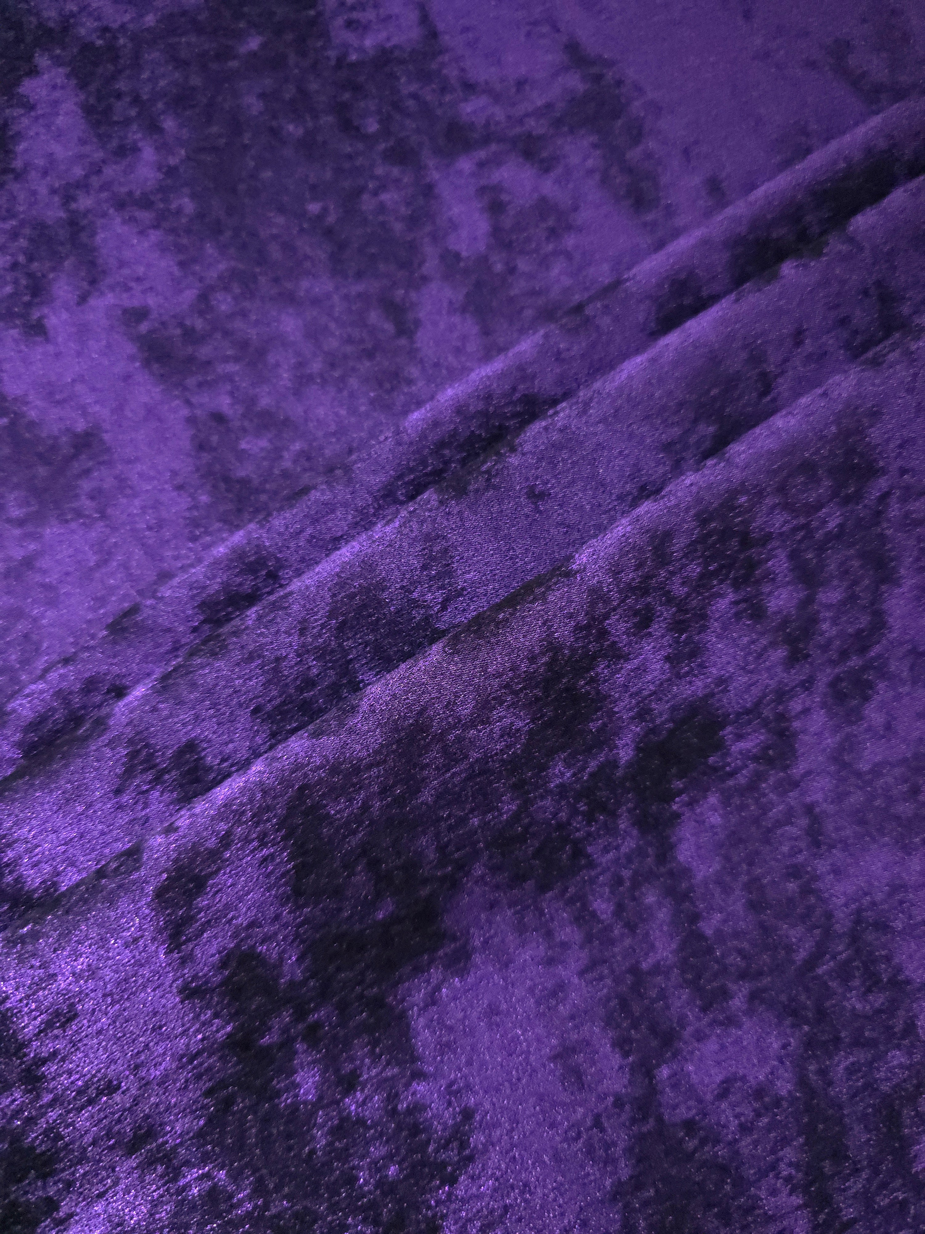 Royal Purple Lurex Italiano fabric in diagonal folds showing metallic sheen and drape for eveningwear.