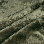 Sage Olive Lurex Italiano fabric in diagonal folds showing metallic sheen and drape for eveningwear.