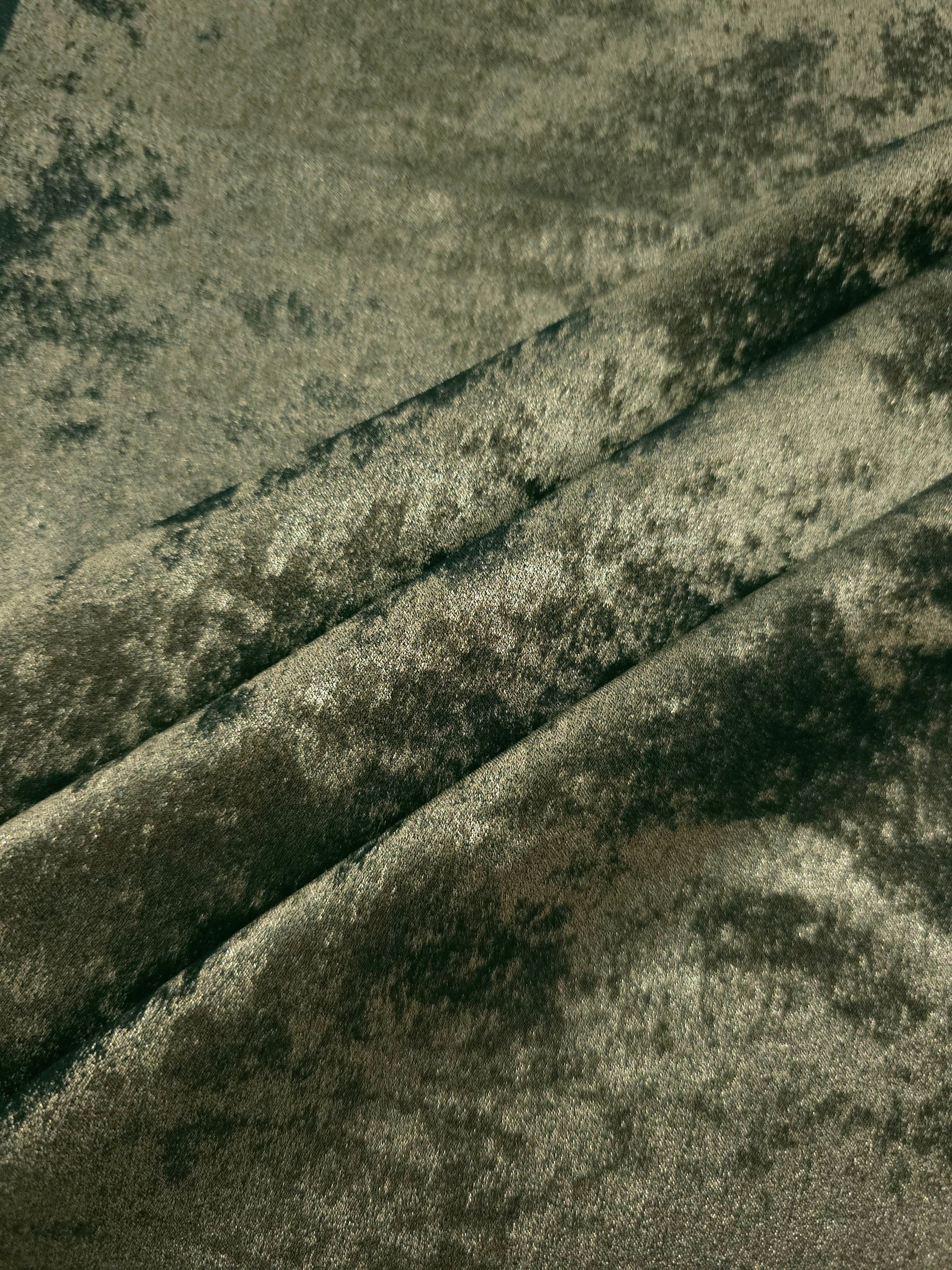 Sage Olive Lurex Italiano fabric in diagonal folds showing metallic sheen and drape for eveningwear.