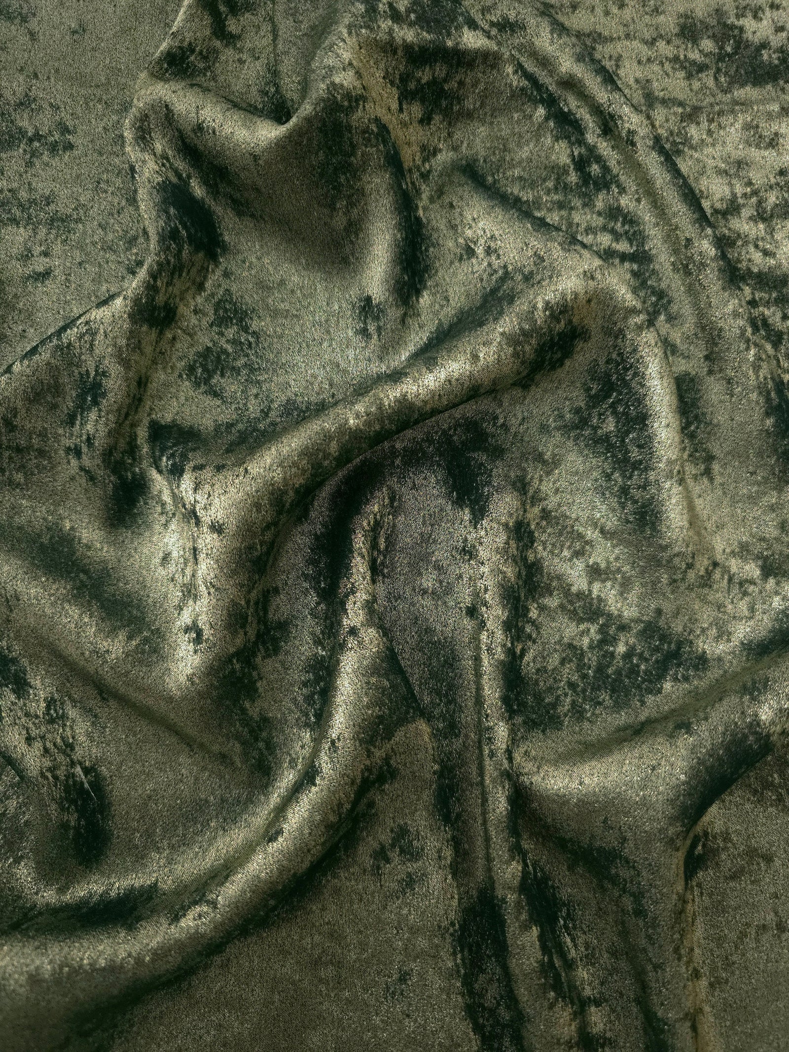 Flowing folds of Sage Olive Lurex Italiano fabric highlighting drape for abayas, kaftans and dresses.