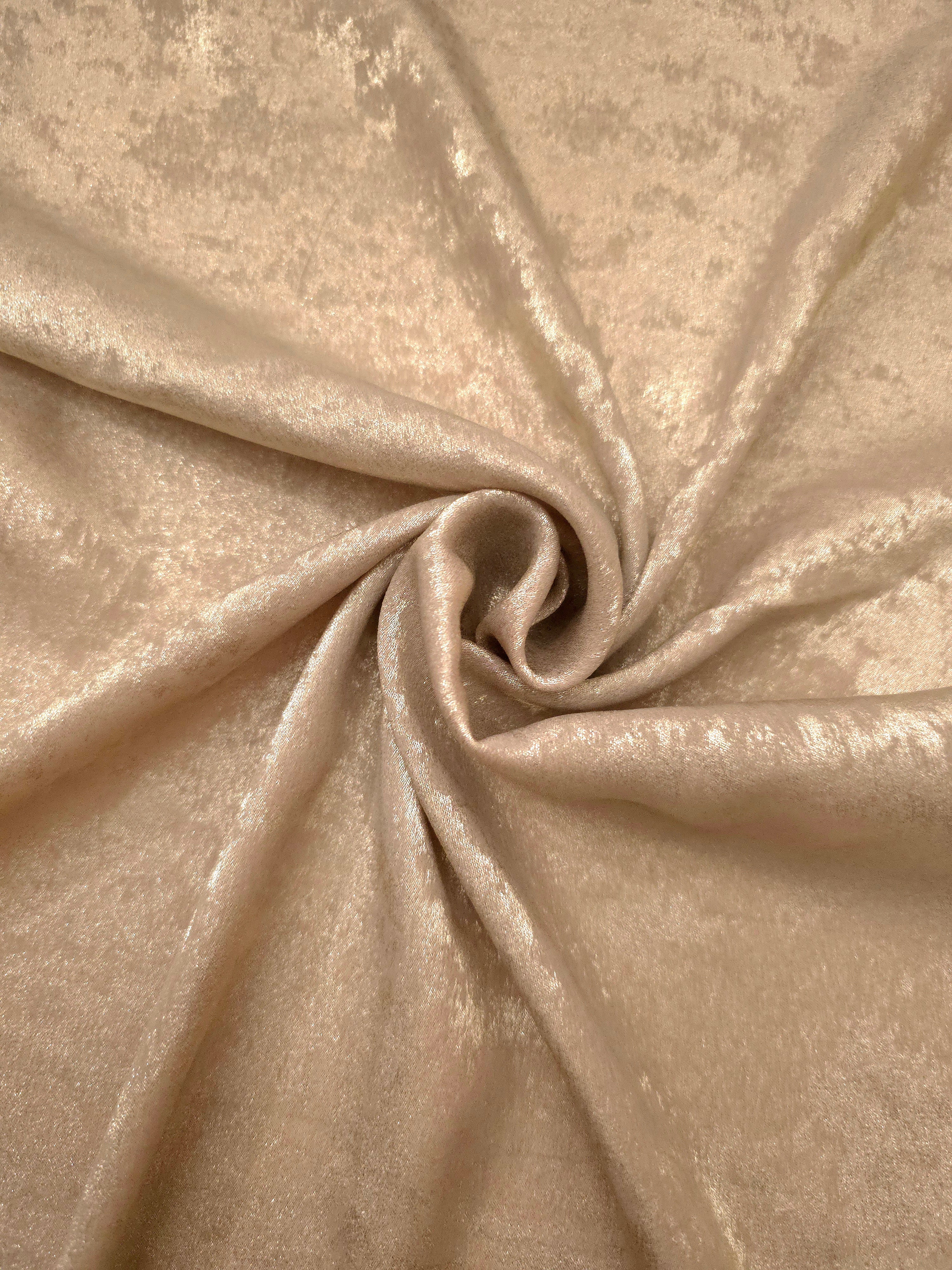 Sand Gold Lurex Italiano metallic fabric in a rosette drape with warm shimmer
