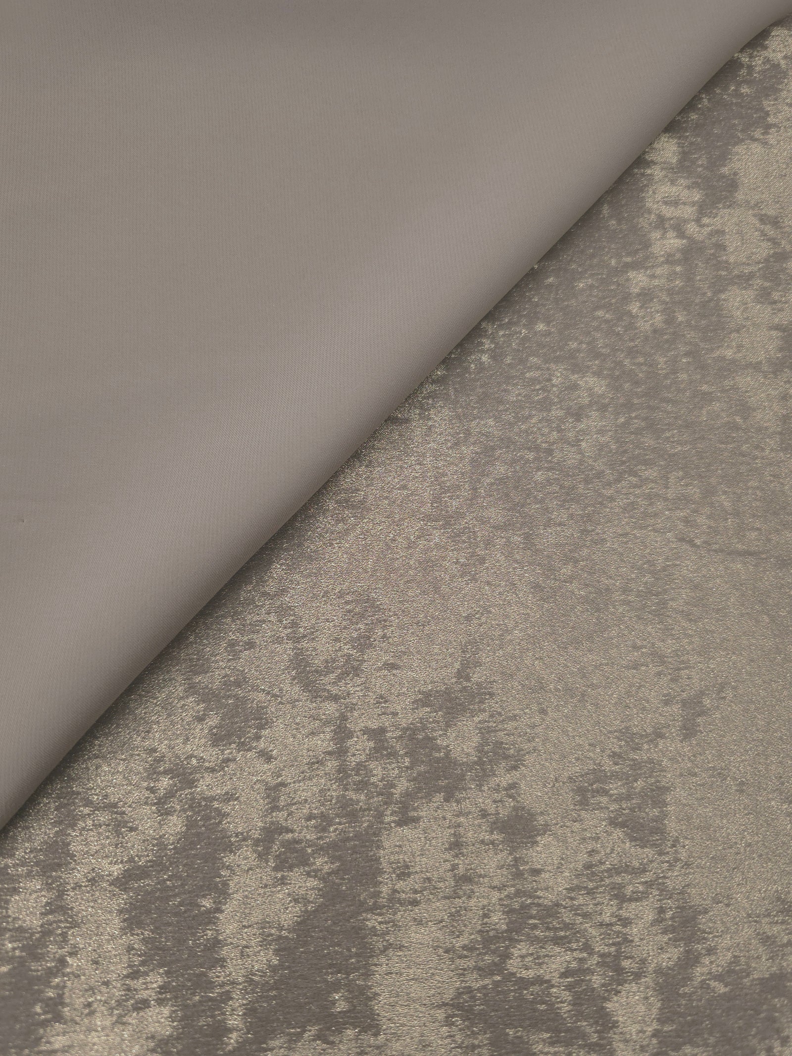 Macro close-up of Stone Greige Lurex Italiano fabric revealing metallic texture for designer apparel.