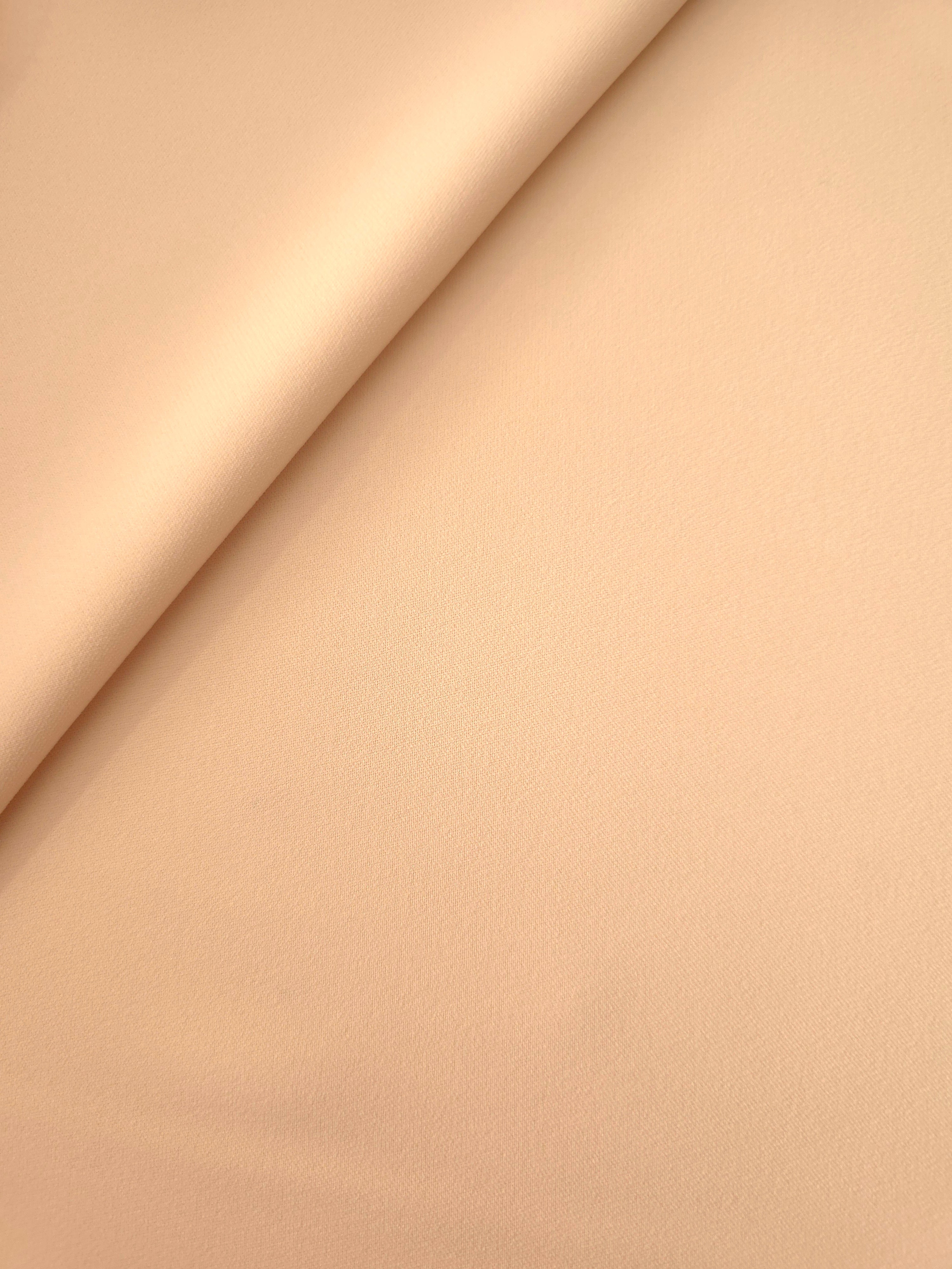 Soft-fold Apricot Nude Silky Italian Crepe showing fluid drape through soft folds, suited to kaftans, long skirts and fluid occasionwear.