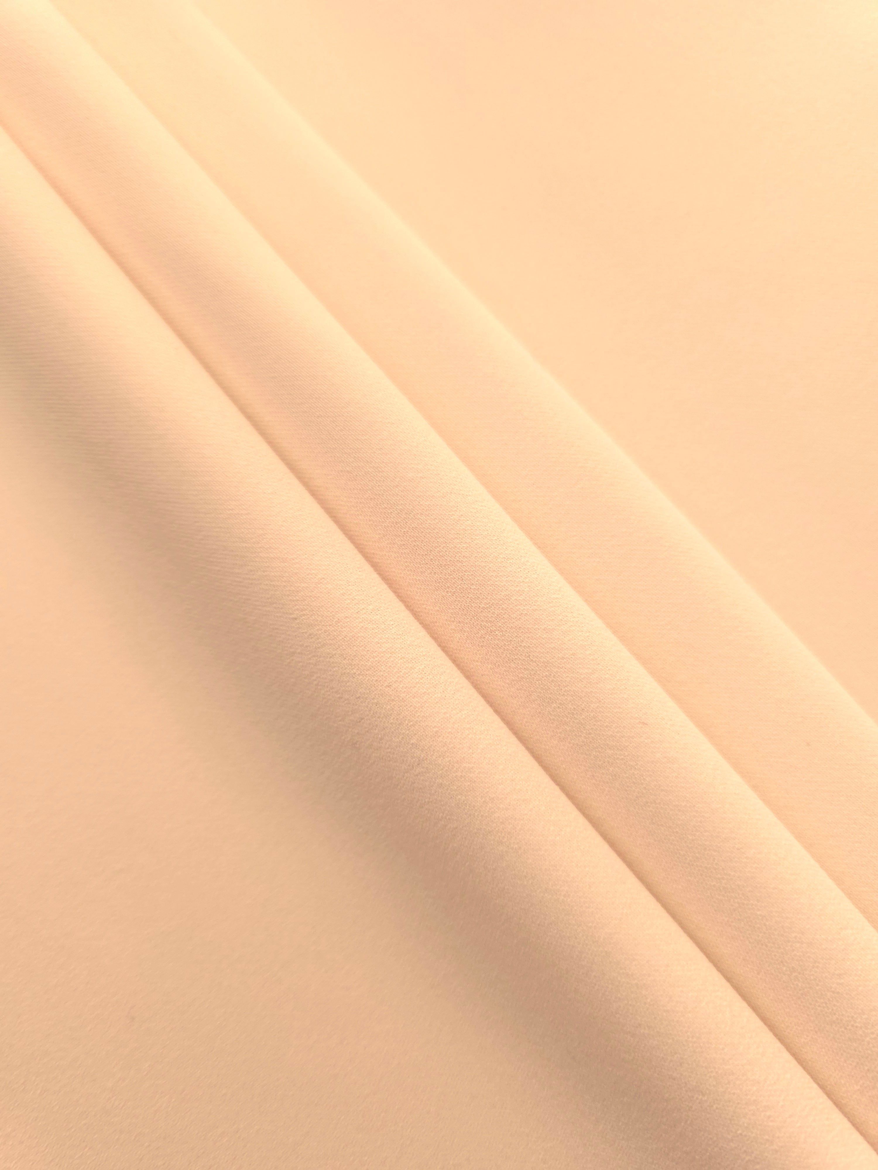 Layered Apricot Nude Silky Italian Crepe showing soft structure in layered folds, suitable for occasion gowns, tunics and lightweight tailored pieces.