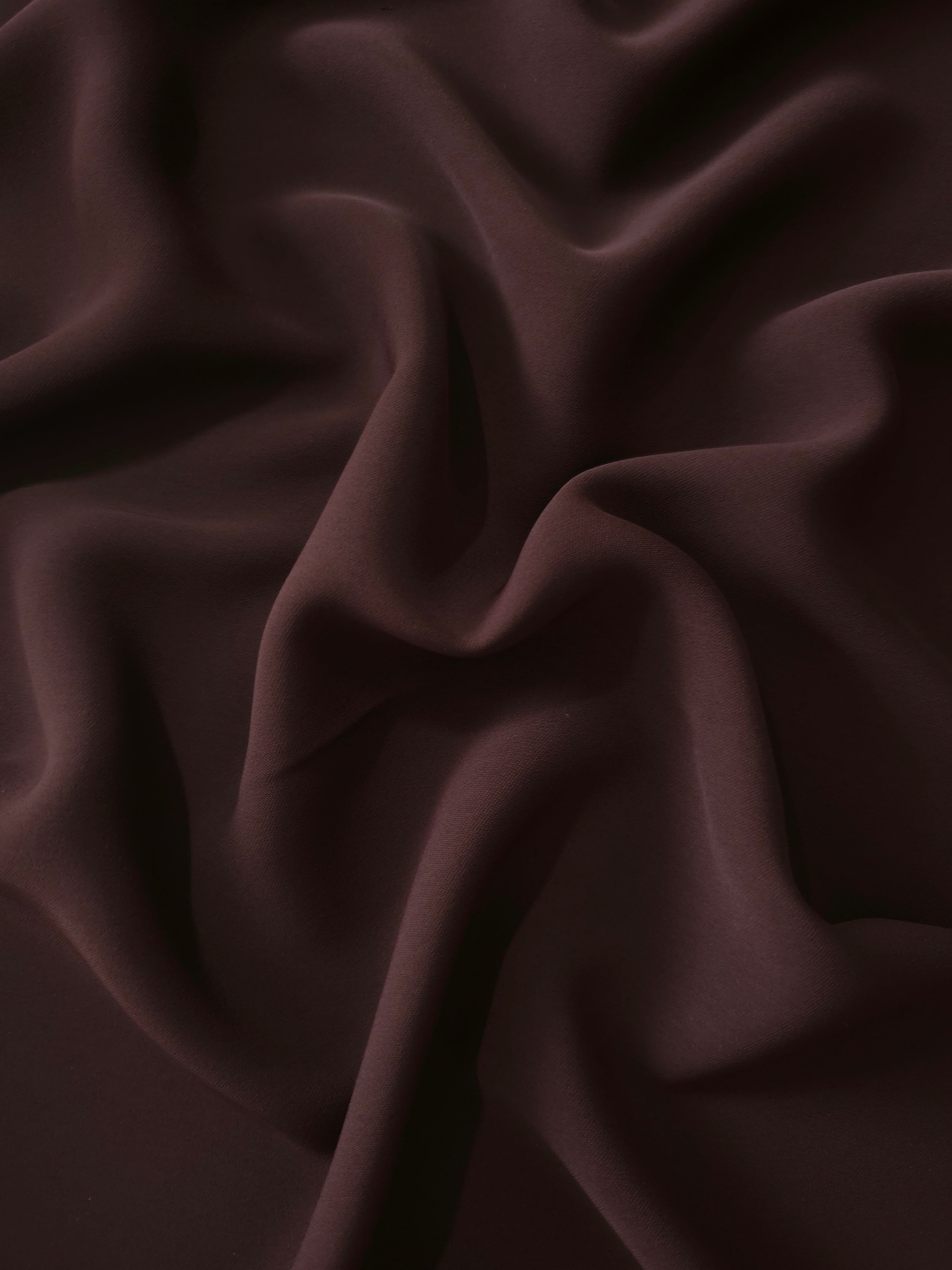 Draped Black Cherry Brown Silky Italian Crepe showing an elegant fall through draped folds, ideal for occasion gowns, tunics and lightweight tailored pieces.