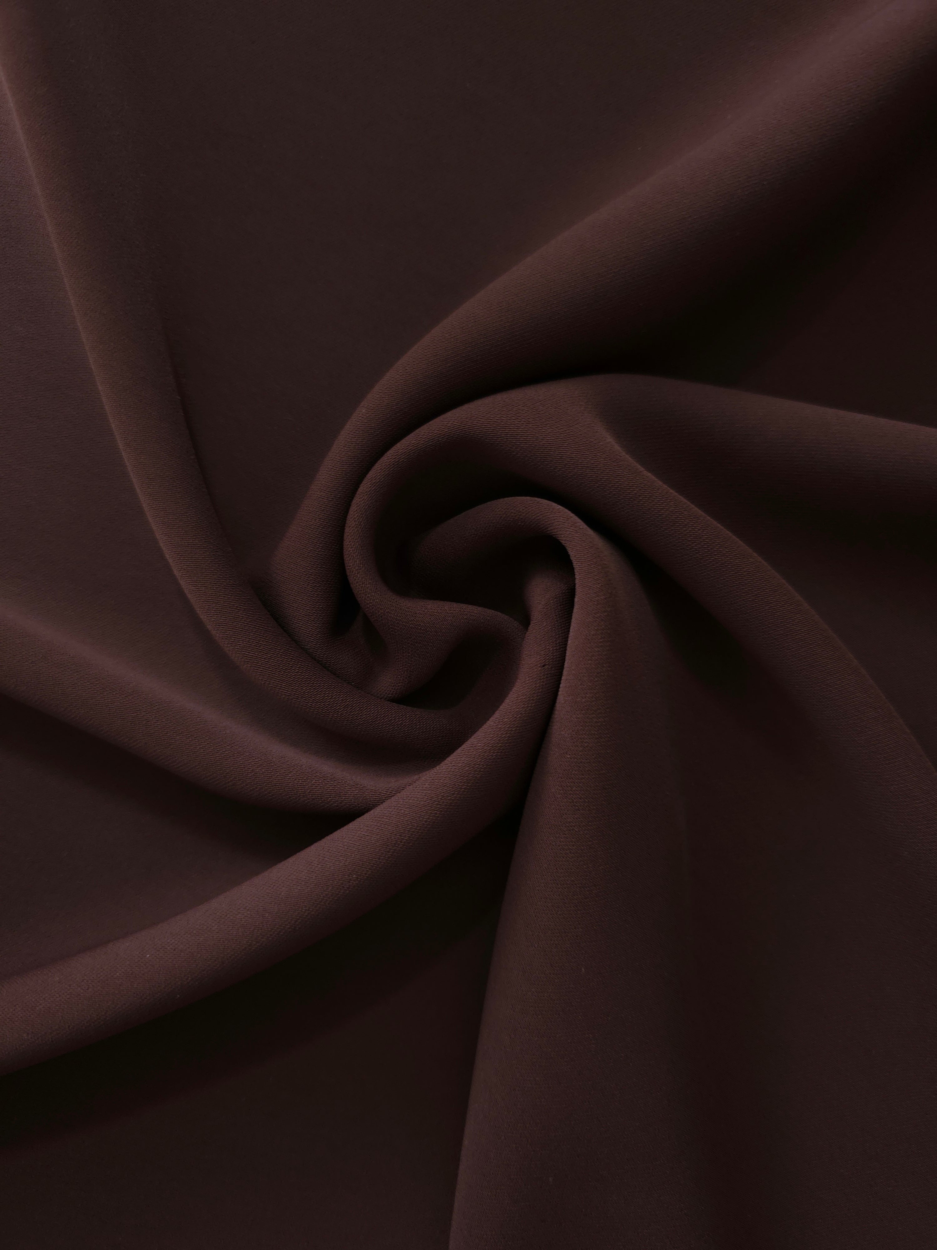 Swirled Black Cherry Brown Silky Italian Crepe showing flowing movement in a swirl drape, versatile for blouses, midi skirts and modest dresses.