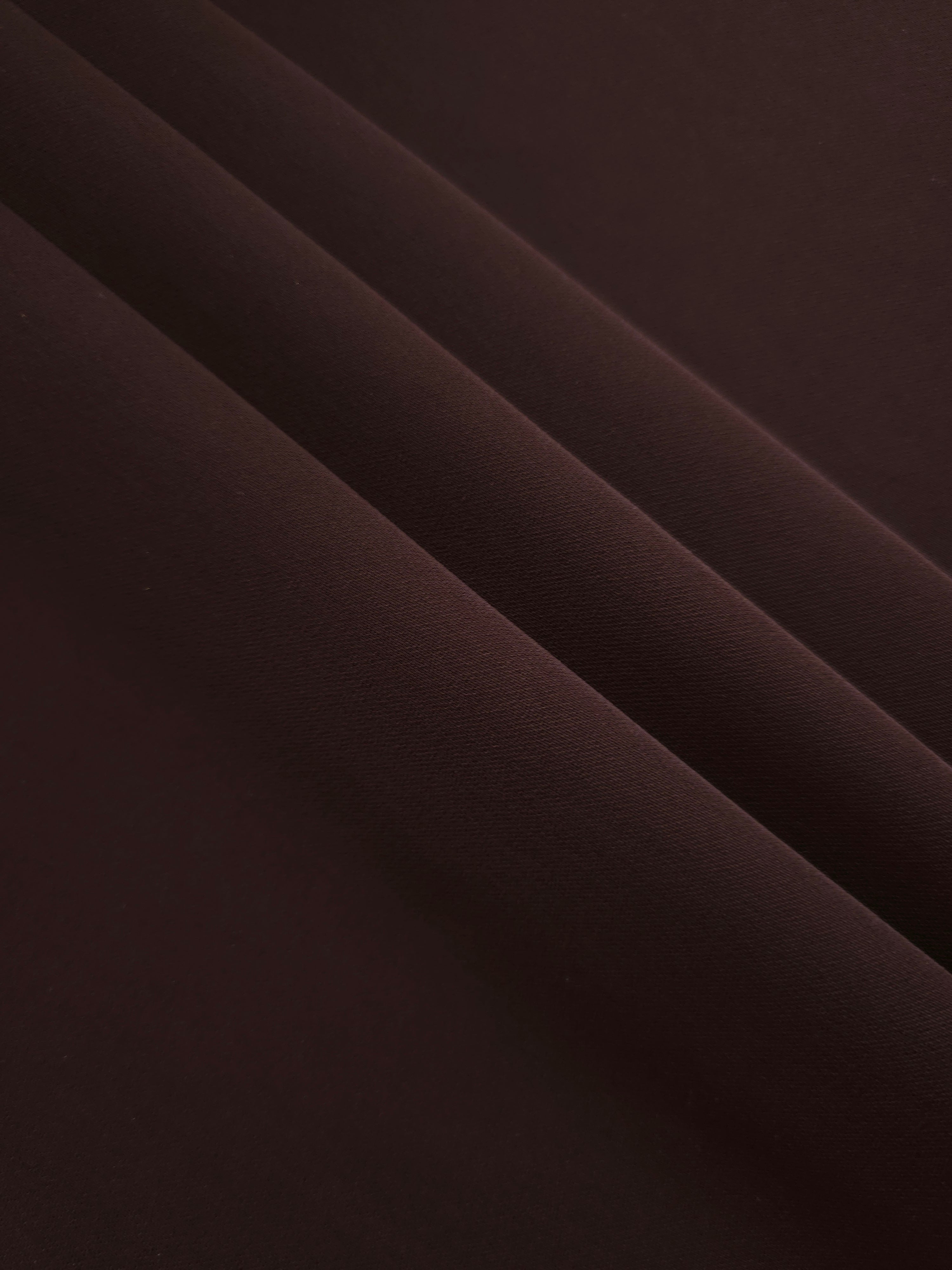 Layered Black Cherry Brown Silky Italian Crepe showing soft structure in layered folds, suitable for abayas, tunics and elegant shirt dresses.
