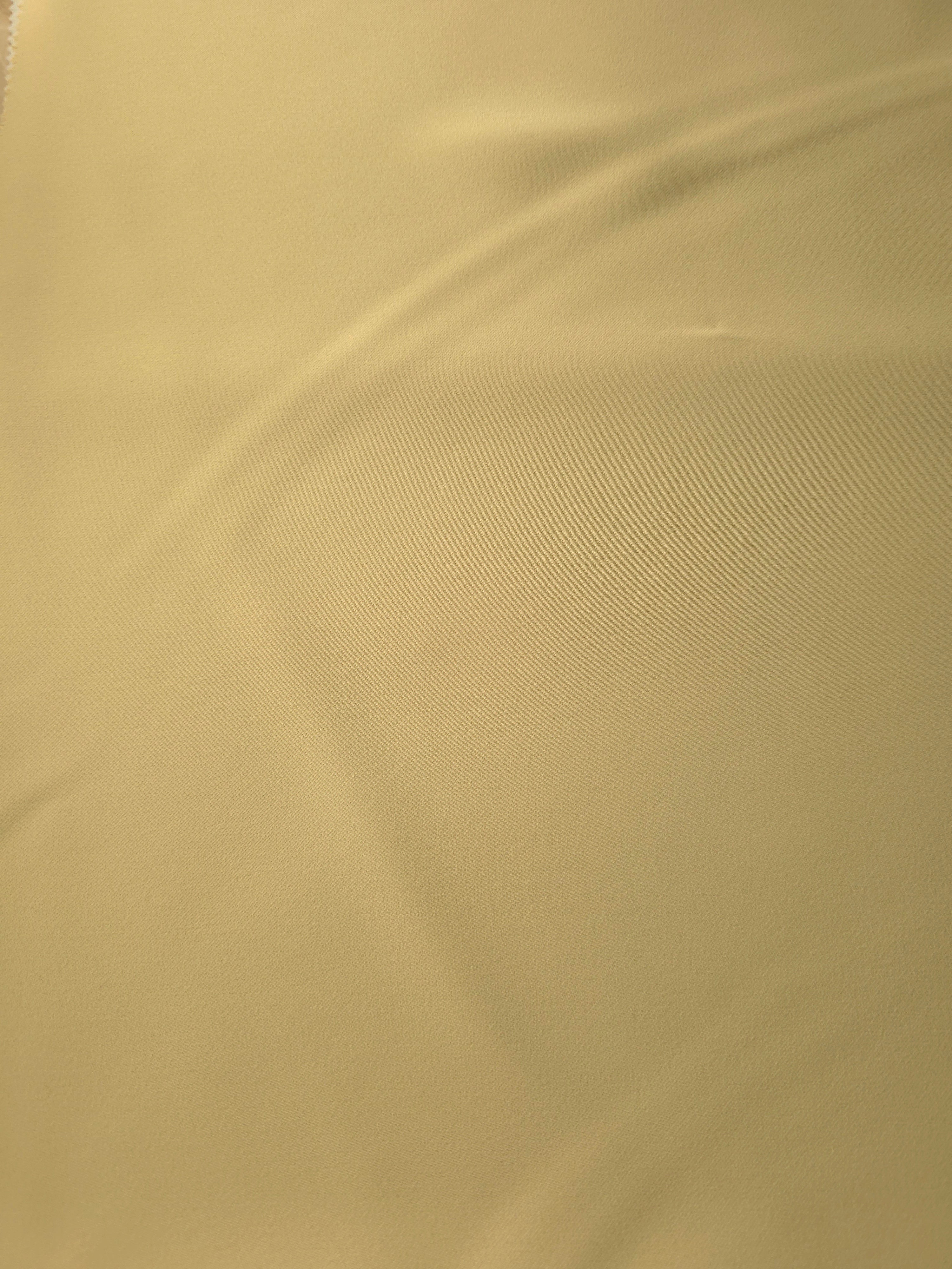 Buttercream Gold Silky Italian Crepe with a smooth opaque finish, suitable for bridesmaid dresses, blouses and refined separates.