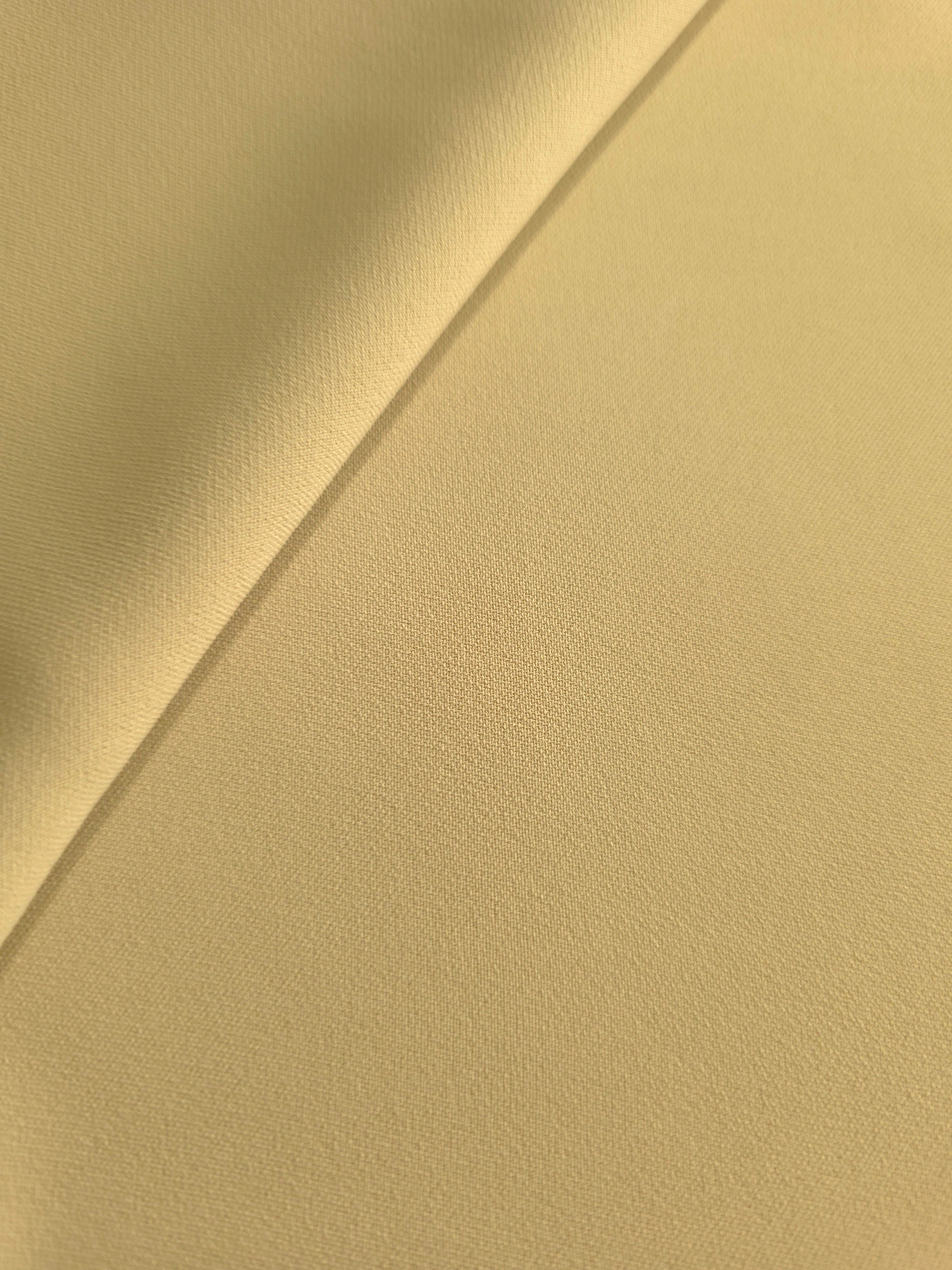 Soft-fold Buttercream Gold Silky Italian Crepe showing fluid drape through soft folds, suited to formal gowns, abayas and special-occasion skirts.