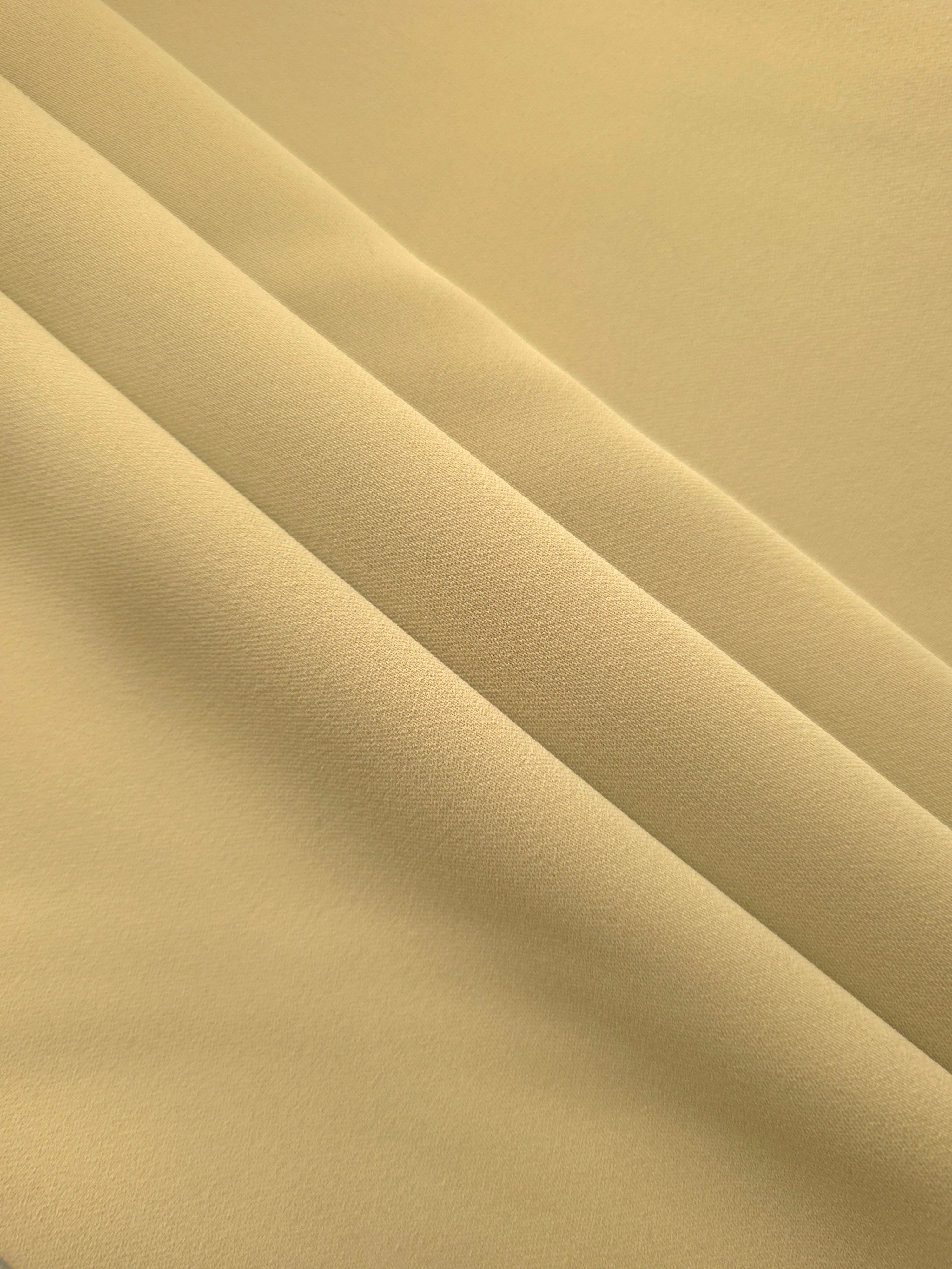 Layered Buttercream Gold Silky Italian Crepe showing soft structure in layered folds, suitable for draped dresses, elegant tops and modest fashion.