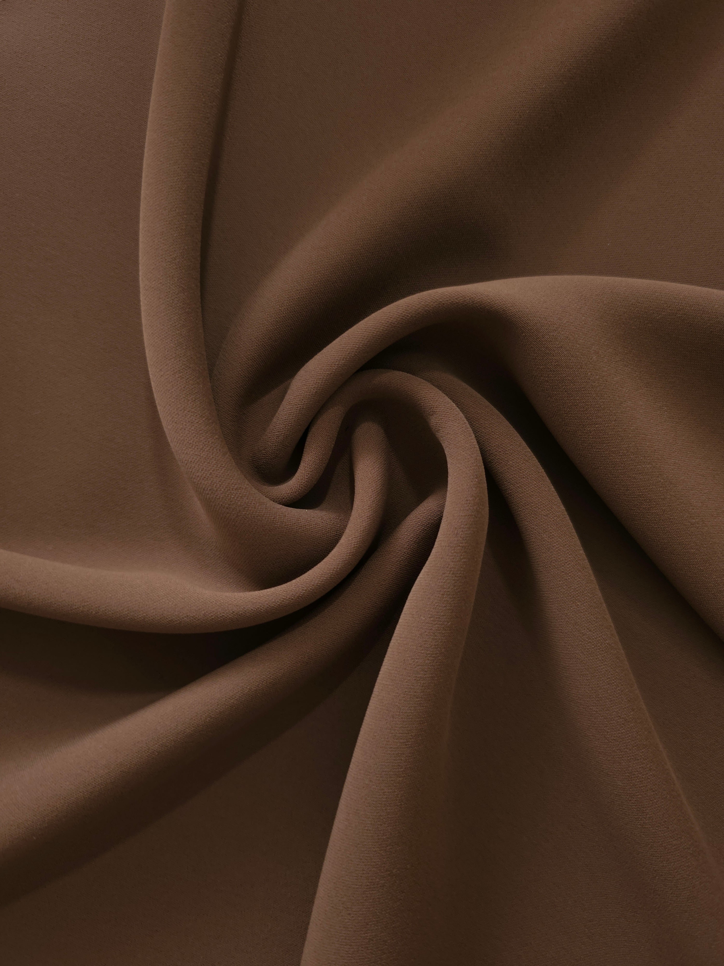 Swirled Cocoa Taupe Silky Italian Crepe showing flowing movement in a swirl drape, versatile for kaftans, long skirts and fluid occasionwear.