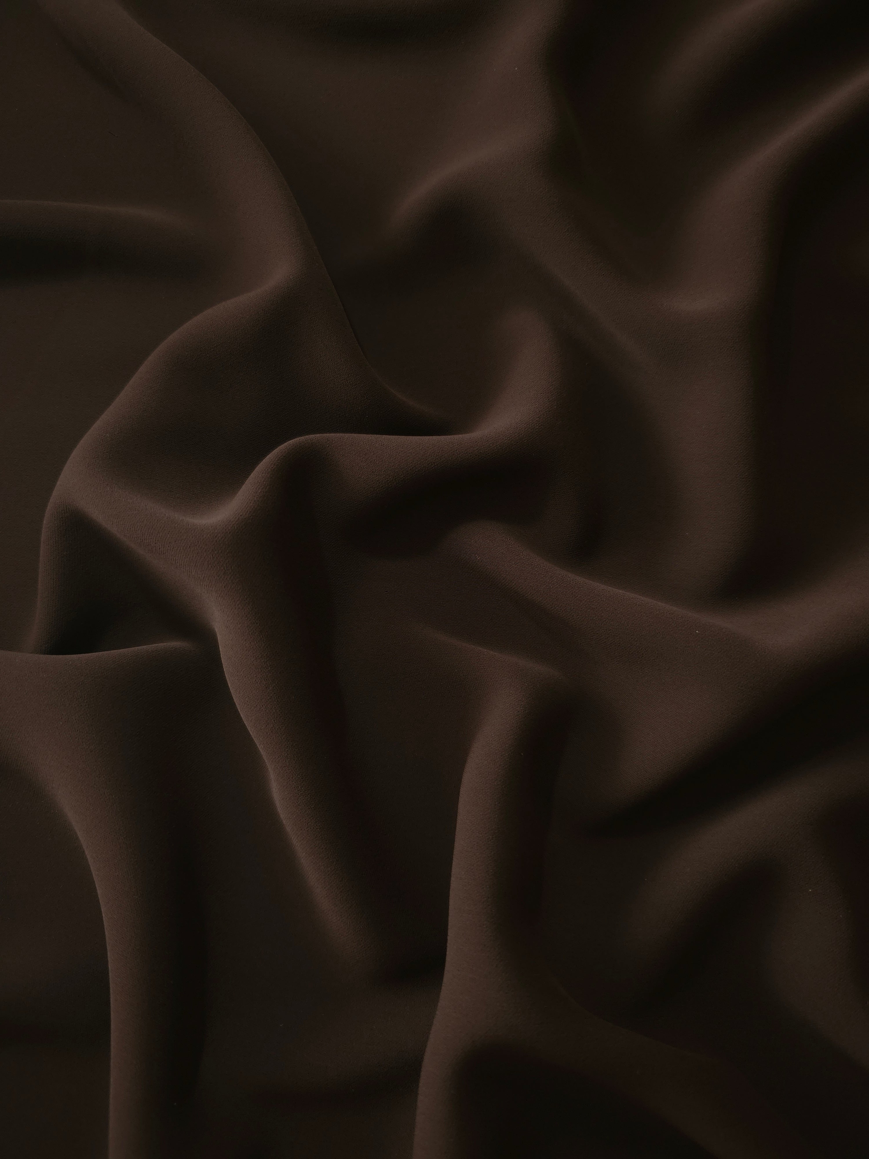 Draped Deep Espresso Silky Italian Crepe showing an elegant fall through draped folds, ideal for occasion gowns, tunics and lightweight tailored pieces.