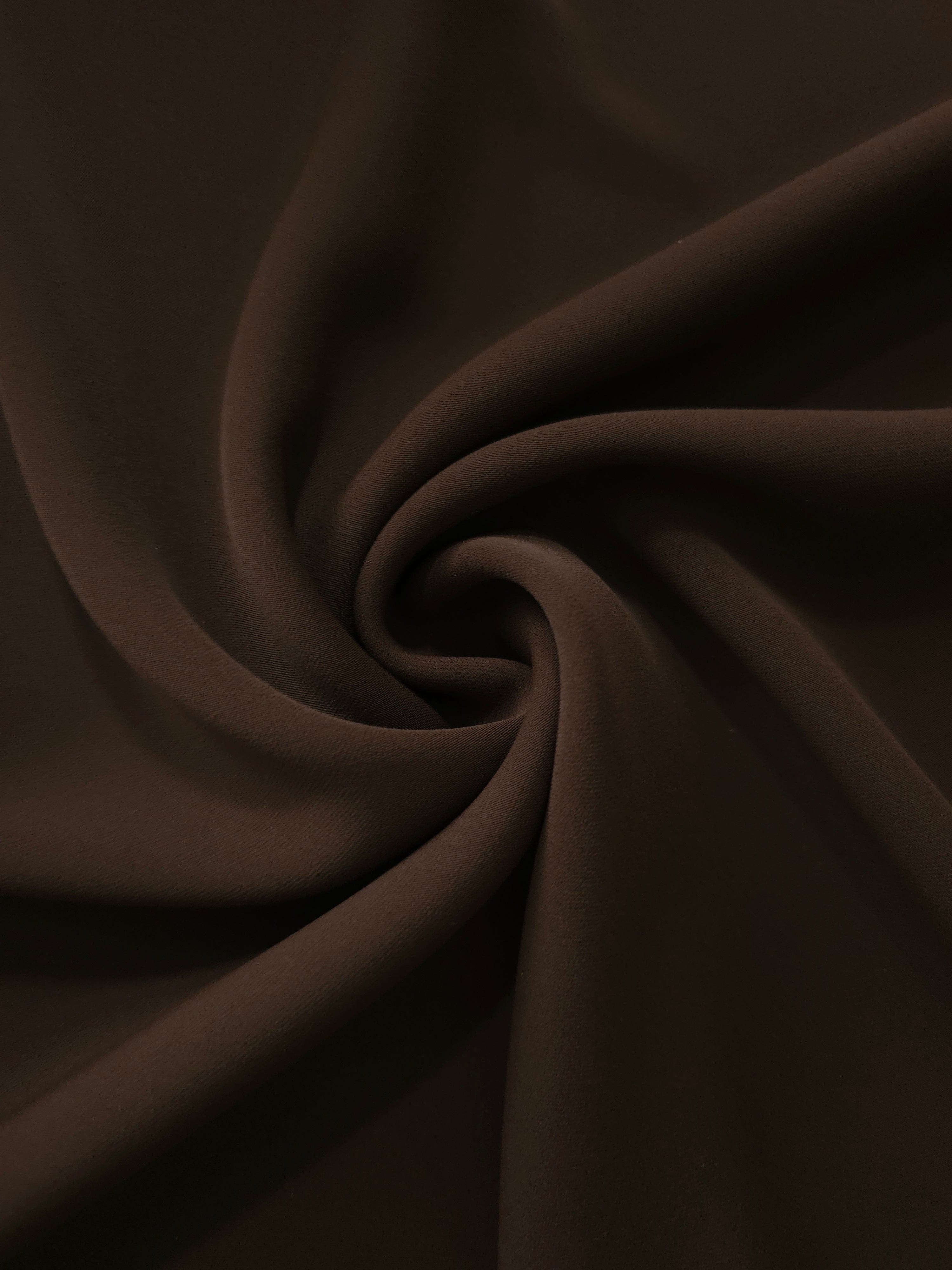Swirled Deep Espresso Silky Italian Crepe showing flowing movement in a swirl drape, versatile for blouses, midi skirts and modest dresses.