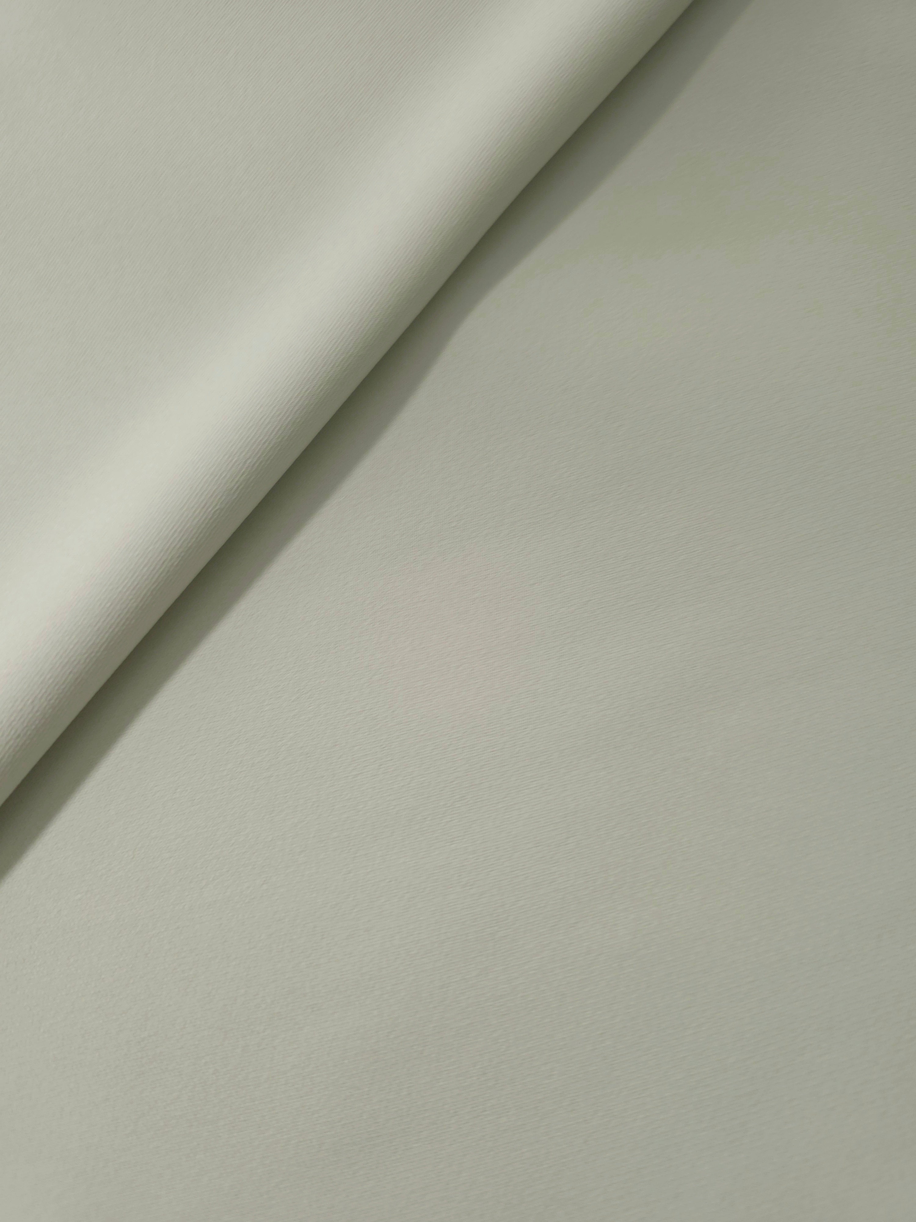 Soft-fold Frosted Ivory Silky Italian Crepe showing fluid drape through soft folds, suited to blouses, midi skirts and modest dresses.