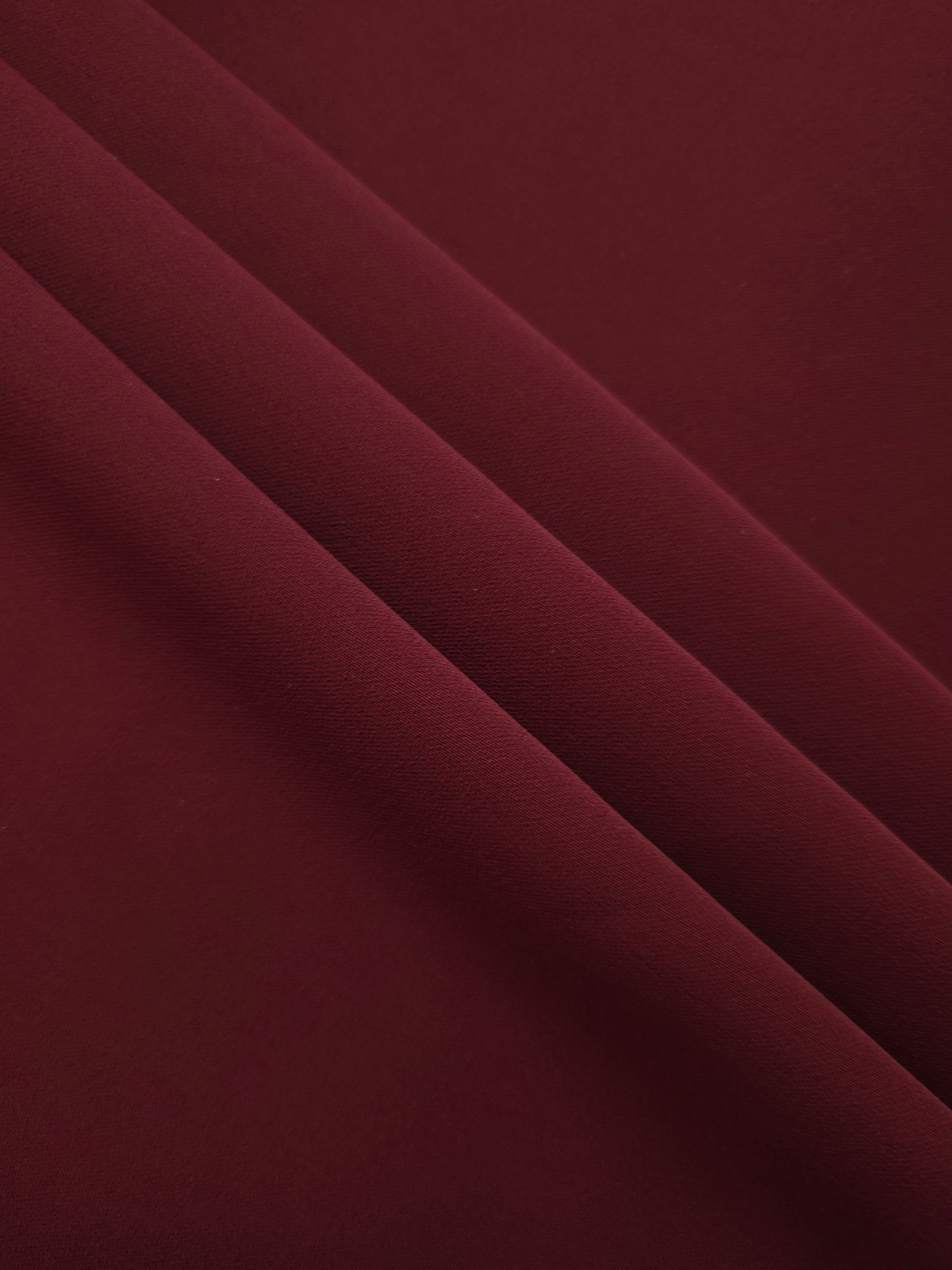 Layered Garnet Wine Silky Italian Crepe showing soft structure in layered folds, suitable for occasion gowns, tunics and lightweight tailored pieces.