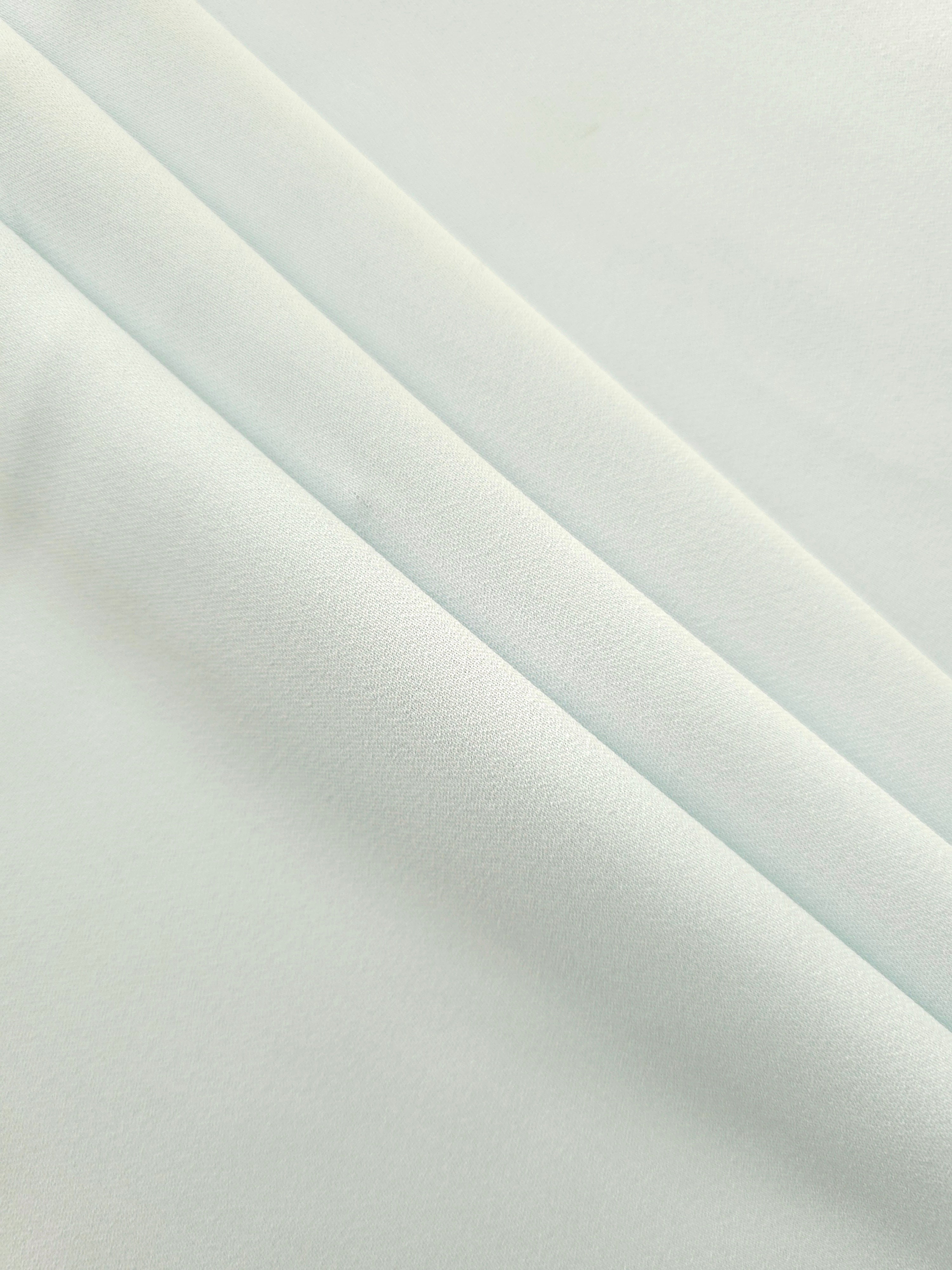 Layered Glacial Mint Silky Italian Crepe showing soft structure in layered folds, suitable for wrap dresses, wide-leg trousers and dressy co-ords.