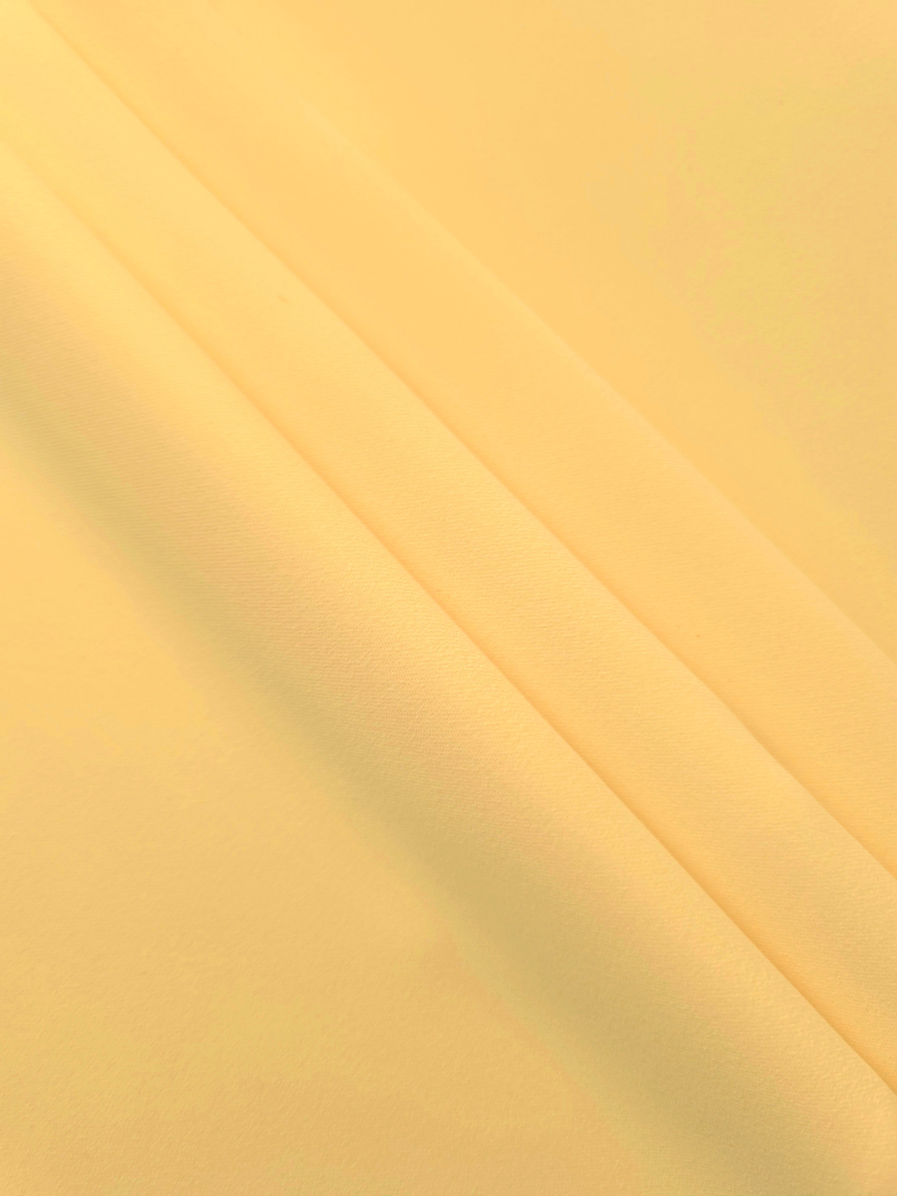 Layered Honey Marigold Silky Italian Crepe showing soft structure in layered folds, suitable for office blouses, tailored dresses and soft jackets.