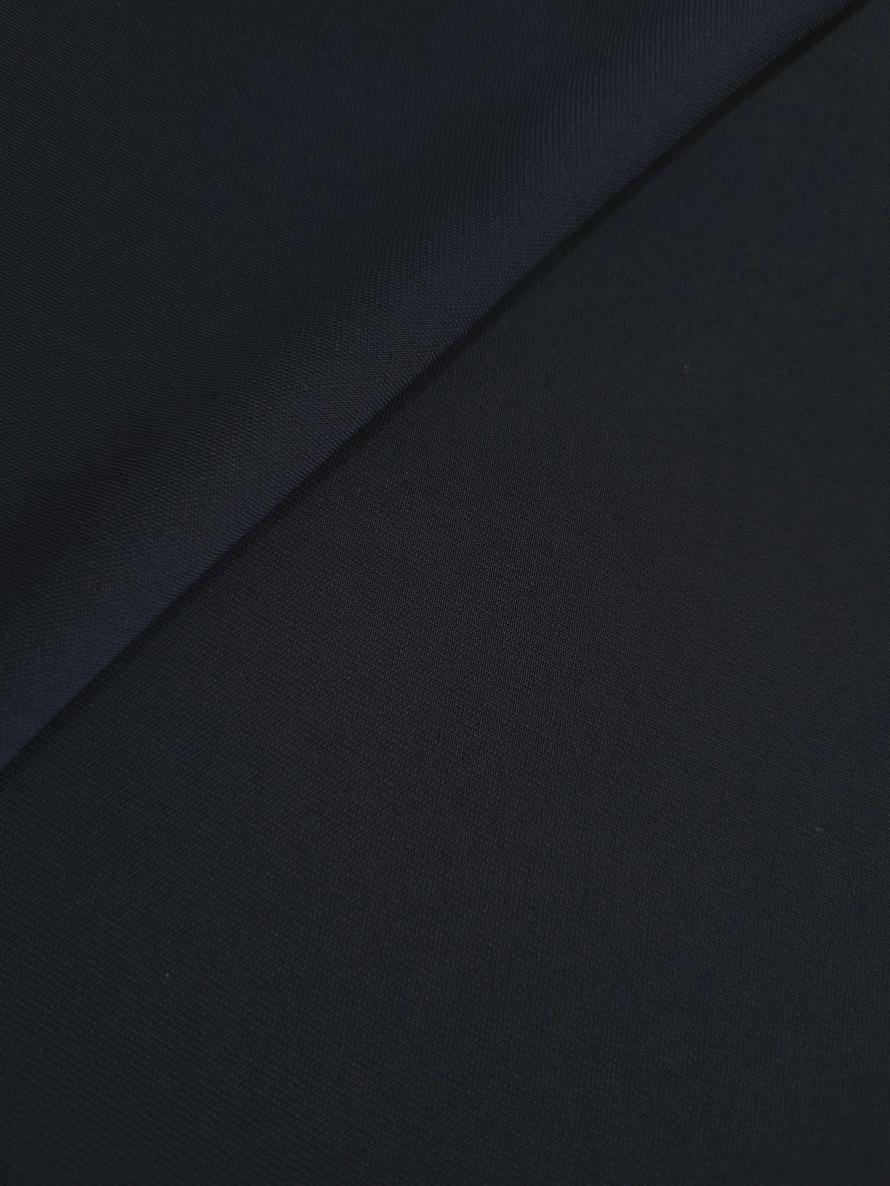 Soft-fold Ink Blue Black Silky Italian Crepe showing fluid drape through soft folds, suited to evening dresses, flowing skirts and occasionwear tops.