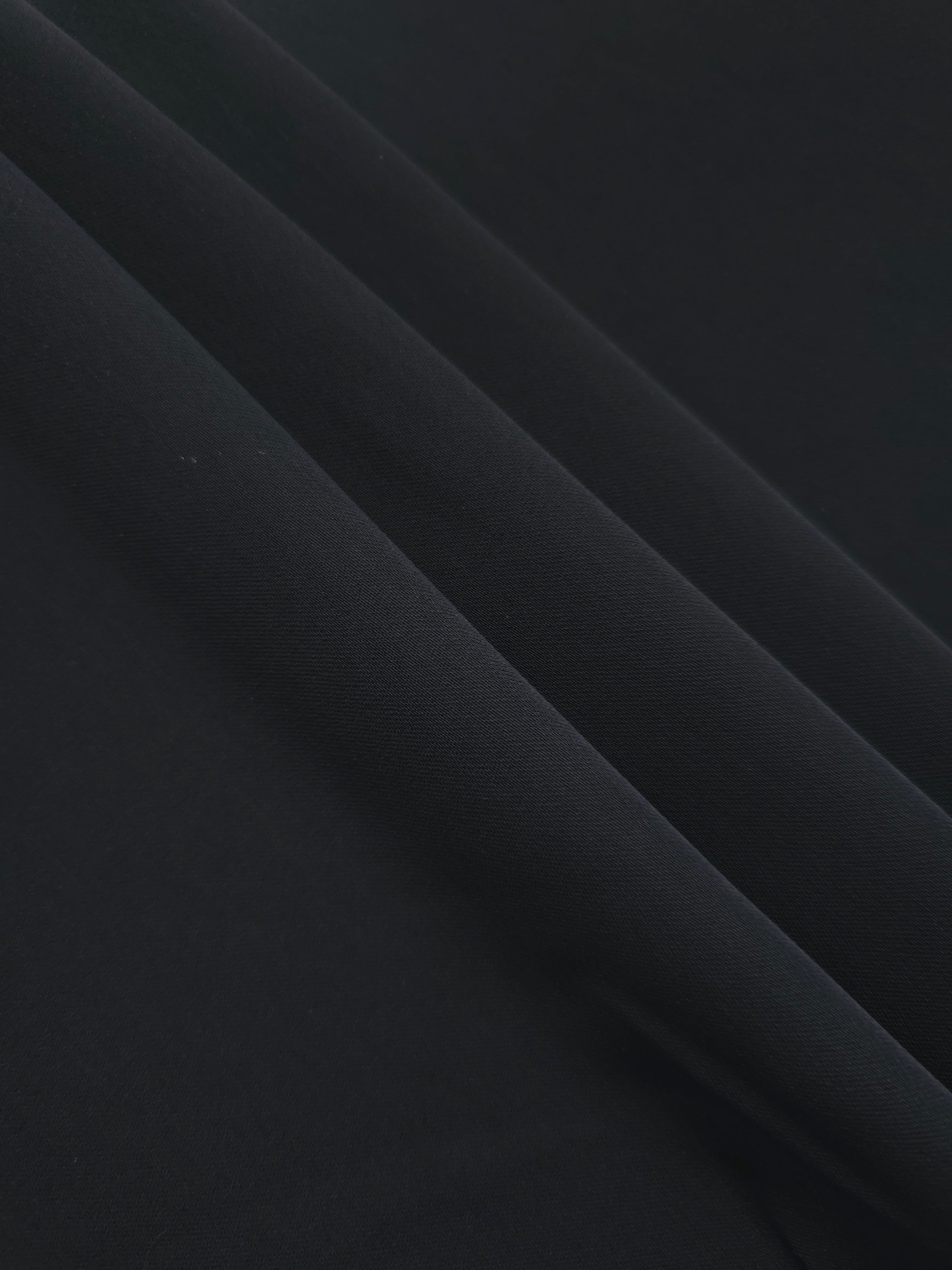 Layered Ink Blue Black Silky Italian Crepe showing soft structure in layered folds, suitable for wrap dresses, wide-leg trousers and dressy co-ords.