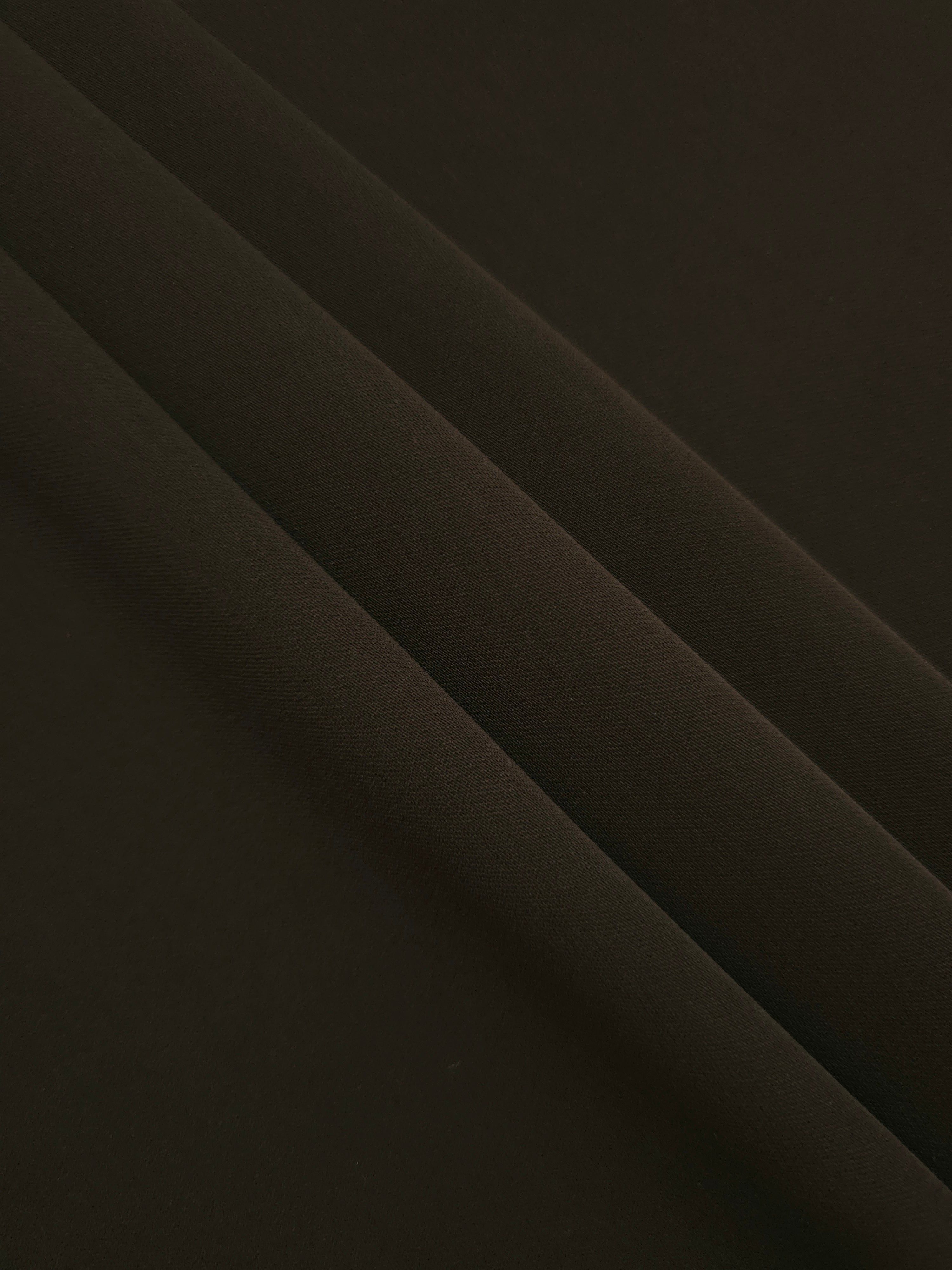 Layered Ink Olive Black Silky Italian Crepe showing soft structure in layered folds, suitable for draped dresses, elegant tops and modest fashion.