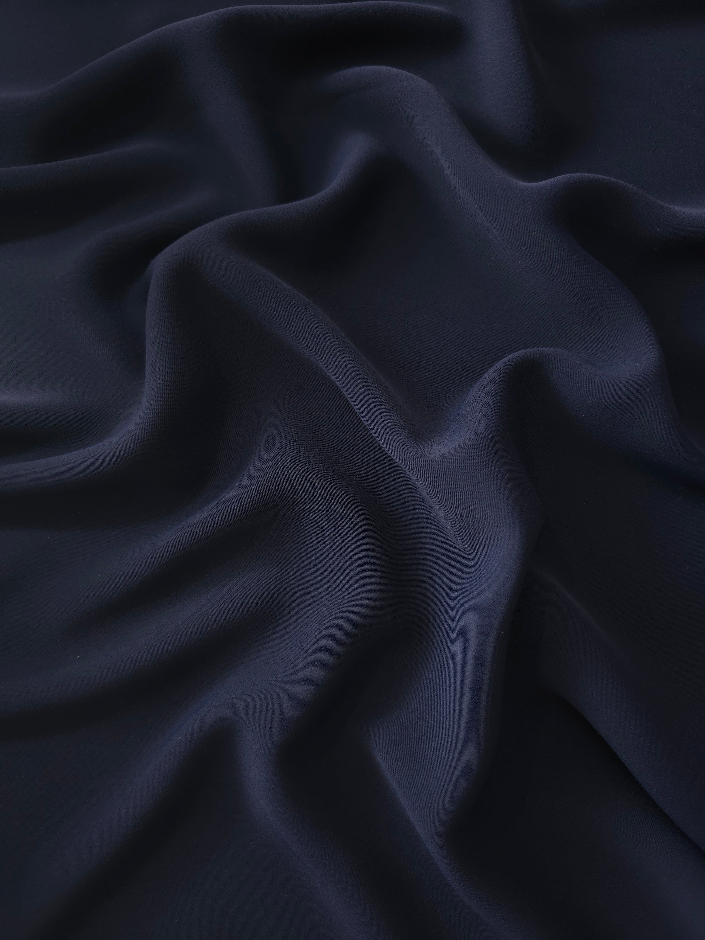 Draped Midnight Marine Silky Italian Crepe showing an elegant fall through draped folds, ideal for office blouses, tailored dresses and soft jackets.