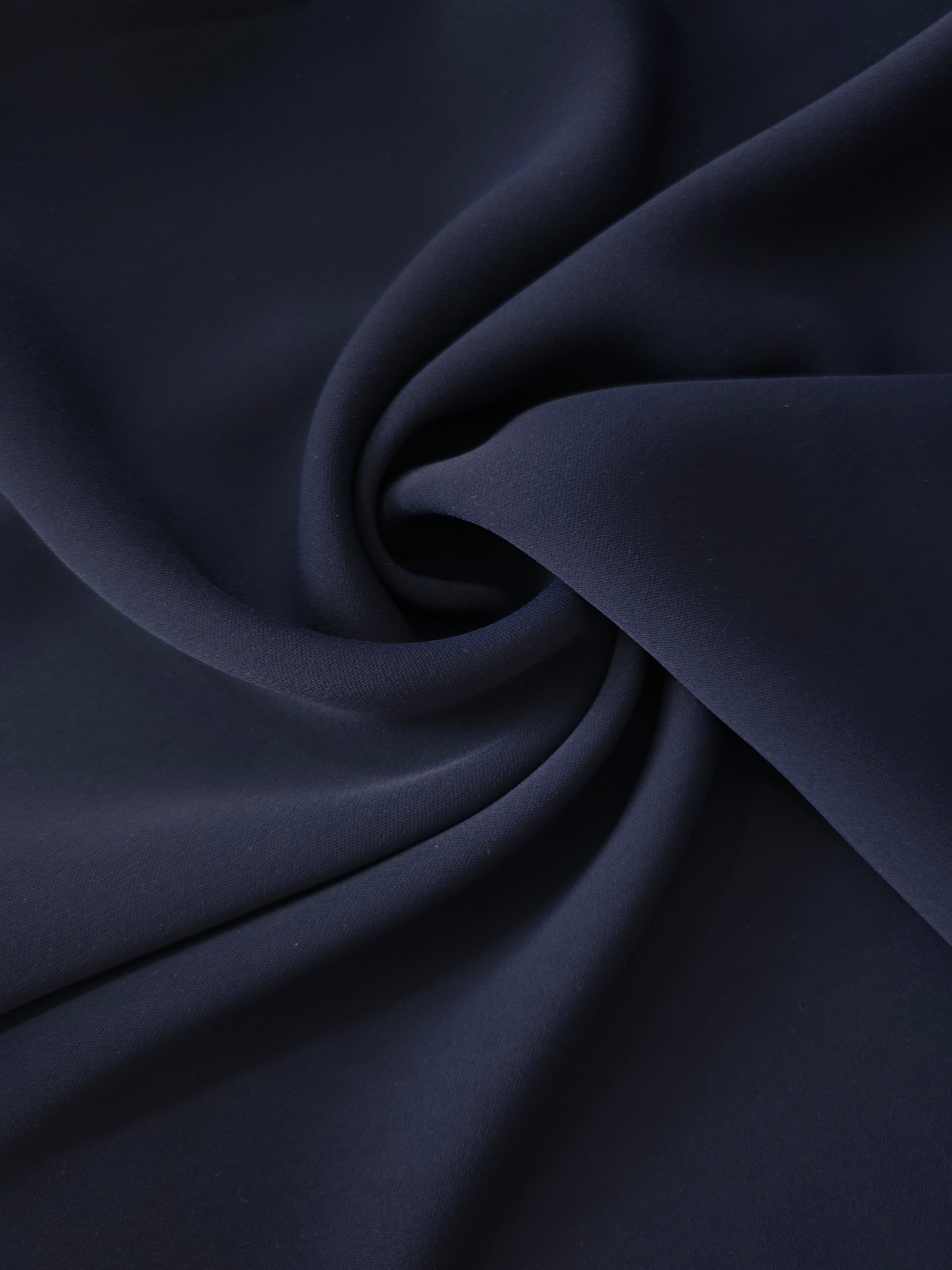 Swirled Midnight Marine Silky Italian Crepe showing flowing movement in a swirl drape, versatile for kaftans, long skirts and fluid occasionwear.